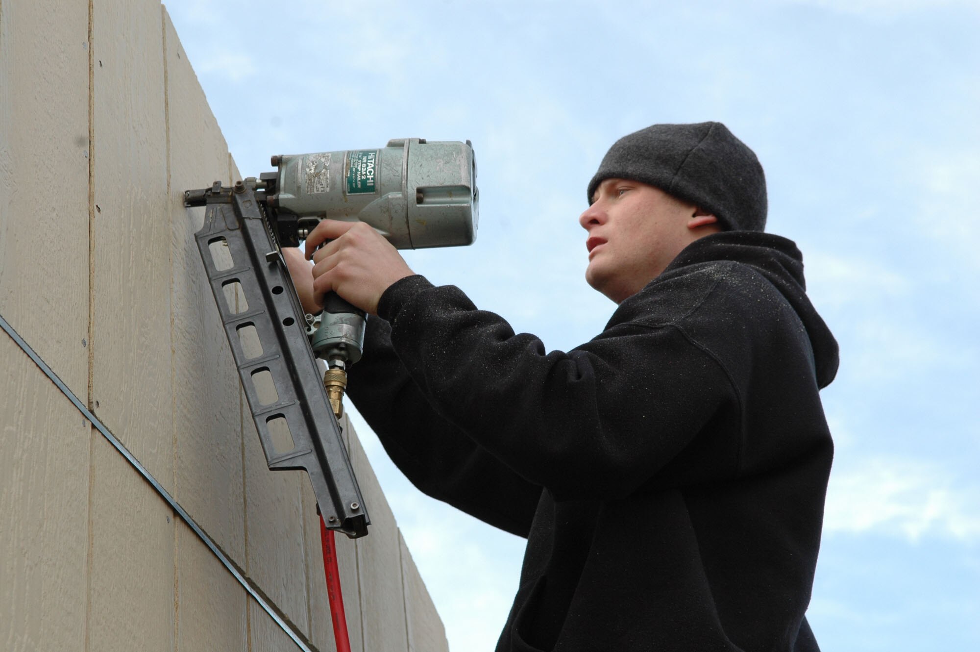 SPOKANE, Wash. – Airman 1st Class Ethan Jago, water survival instructor at the Survival, Evasion, Resistance and Escape School at Fairchild Air Force Base, Wash., works on a Habitat for Humanity house March 13 on Union Street here. This is the first time Airman Jago has volunteered for Habitat, though he did “work on houses before the military, just for fun,” he said. “It’s definitely a great feeling, helping someone out,” he said of his volunteer experience. (U.S. Air Force photo / Tech. Sgt. Larry W. Carpenter Jr.)