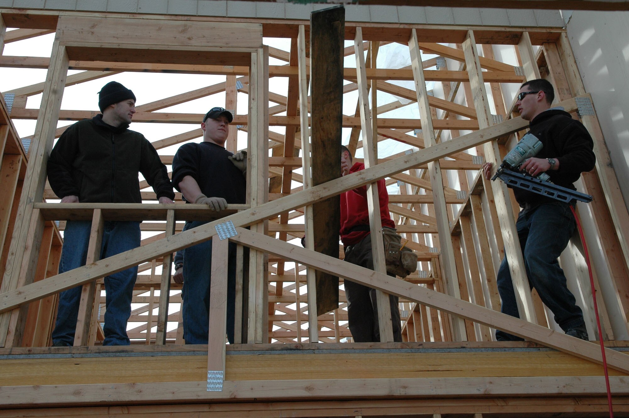 SPOKANE, Wash. – From left, Senior Airmen Steven McGrath and Chris Ceaser, and Staff Sgt. Paul Maples, all from the 66th Training Squadron at Fairchild Air Force Base, Wash., build the structure of a Habitat for Humanity home here March 13. The Airmen had the day off from their jobs at the Survival, Evasion, Resistance and Escape School at Fairchild, and opted to spend that day at the Habitat-Spokane site. Many of the Airmen volunteers have pre-military construction experience, according to Chief Master Sgt. Jon Stuhr, 66th TRS superintendent (U.S. Air Force photo / Tech. Sgt. Larry W. Carpenter Jr.)