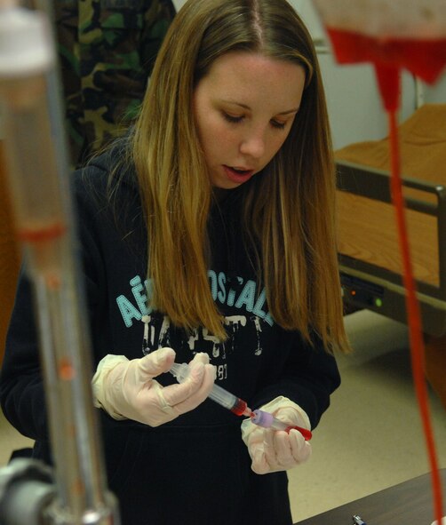 Stefanie Peterson, Licensed Practical Nurse program student, draws fluid from a test tube during hands on training at Western Dakota Technical Institute March 13. As a student in the LPN program Ms. Peterson, will use this training both in exercises at Western Dakota Technical Institute and for obtaining her 160 hours of clinical experience required to obtain her degree. Members of the LPN program will begin to clinical training March 31 at the 28th Medical Group clinic on Ellsworth. (U.S. Air Force photo/Airman 1st Class Adam Grant)