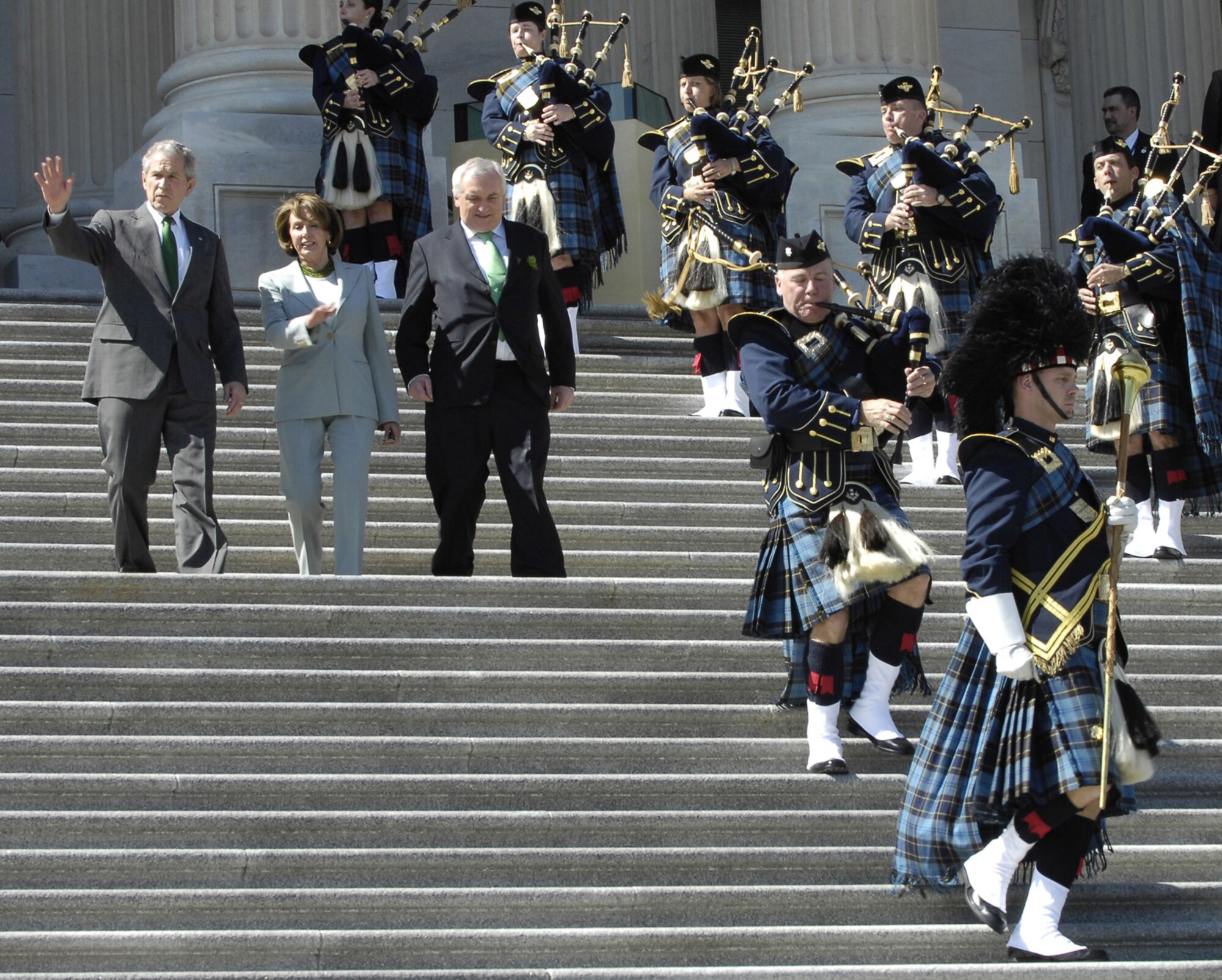 President George W. Bush exits the U.S. Capitol with Speaker of the House Nancy Pelosi and Prime Minister of Ireland Bertie Ahern as members of the U.S. Air Force Reserve Pipe Band play traditional Irish music in Washington, D.C., on March 17, 2008. The band from Robins Air Force Base, Ga., also participated in the St. Patrick's Day Parade in downtown Washington the day before. (U.S. Air Force photo/Senior Airman Alexandre Montes)