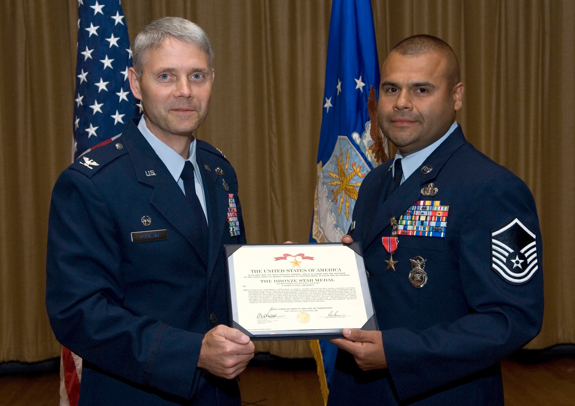 Col. Eric Pohland, 96th Air Base Wing commander, presents a bronze star to Master Sgt. Manuel Camacho, 96th Ground Combat Training Squadron, for his actions during OPeration Iraqi Freedom.