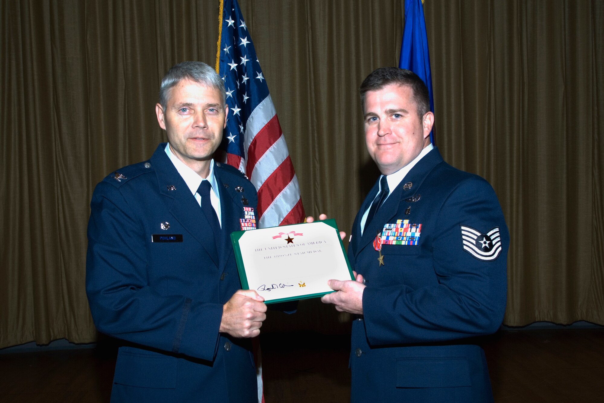 Col. Eric Pohland, 96th Air Base Wing commander, presents a bronze star to Tech Sgt. Kenneth Perry, 96th Civil Engineer Squadron Explosive Ordnance Flight, for his actions during Operation Iraqi Freedom.