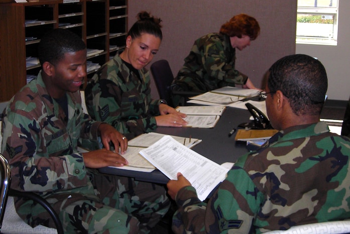 Airman 1st Class Jamal Avington, Tech. Sgt. Debra Rogers, Master Sgt. Shannon Carter and Airman 1st Class Andre Bolden screen Unit Personnel Record Group folders on base Feb. 29.  The records were screened prior to being sent to Air Force Personnel Center for approval before making them virtual. The four Airmen are with the 437th Mission Support Squadron. (U.S. Air Force photo/Chief Master Sgt. Denise Mikolajczyk)