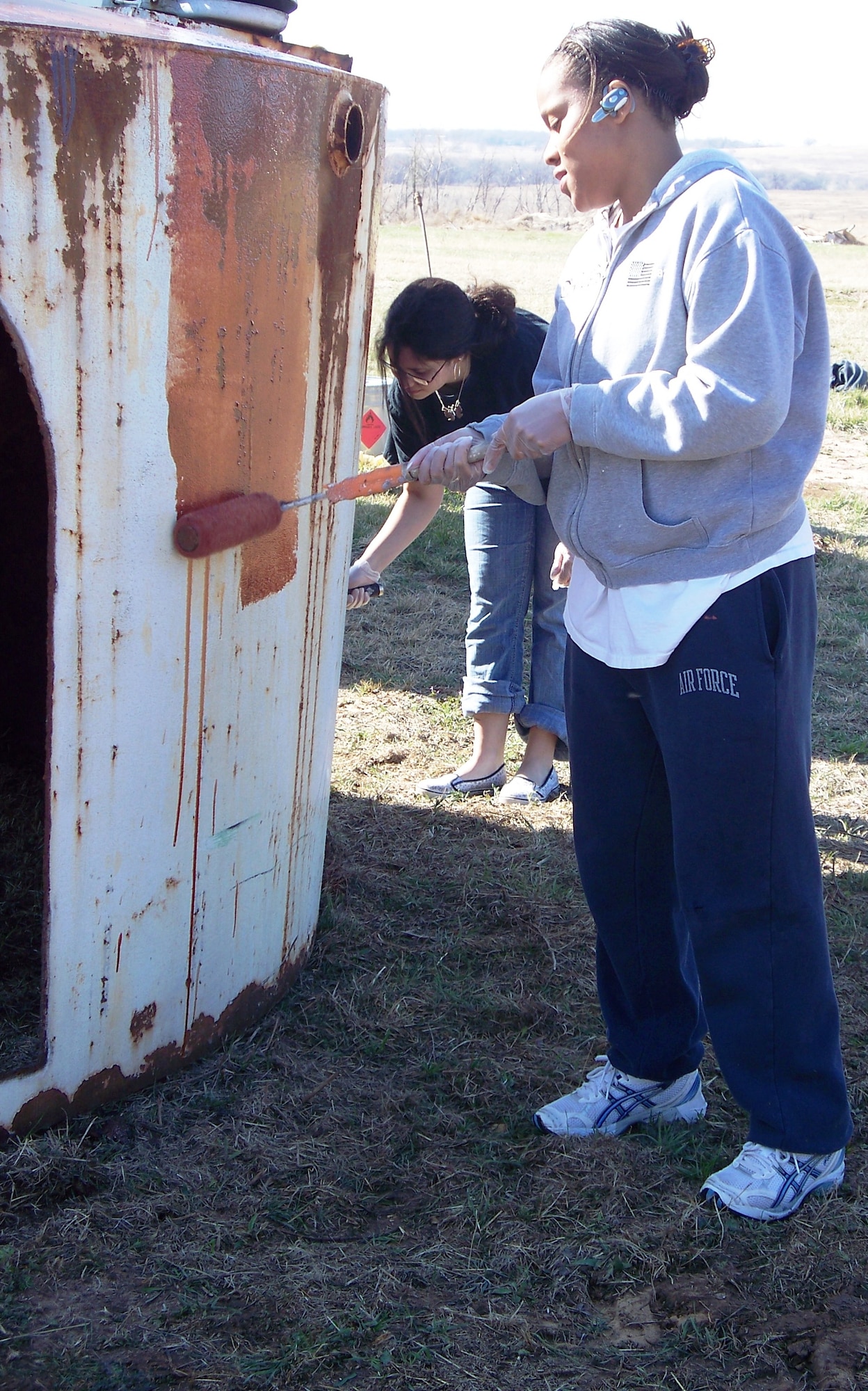 Staff Sgt. Toiseng Torres of the 80th Operations Support Squadron paints a big cat shelter March 14 during the squadron's recent community service project. Twenty-five 80th OSS personnel volunteered time to help the Center for Animal Research and Education, near Bridgeport, Texas, clean up and repair a few areas of the Big Cat Habitat. (U.S. Air Force photo/Airman 1st Class Desiree Straughn)