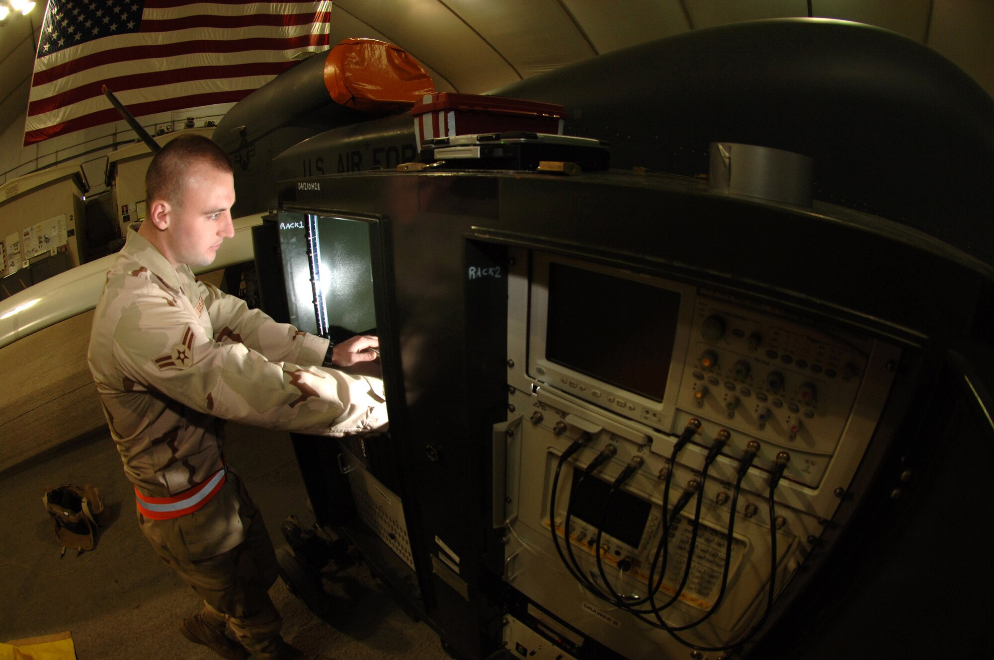 Airman 1st Class Matthew Milles performs an operational check of the Global Hawk's sensor package March 11 in Southwest Asia. The Global Hawk recently reached the 10 year and 20,000 flight hour milestones. Airman Milles is a 380th Expeditionary Aircraft Maintenance Squadron aircraft avionics specialist. (U.S. Air Force photo/Senior Airman Levi Riendeau)