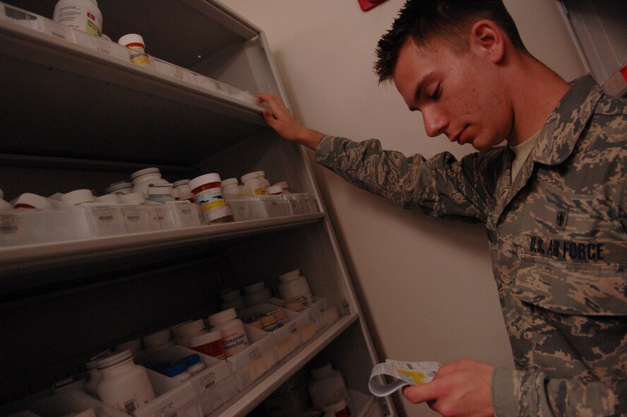 MOODY AIR FORCE BASE, Ga. -- Airman 1st Class Robert Burwell, 23rd Medical Group pharmacy technician, searches for tablets, which will later be counted for a medical patients prescription here March 18. The Moody pharmacy provides prescriptions daily from 8 a.m. to 5 p.m. (U.S. Air Force photo by Senior Airman Gina Chiaverotti)