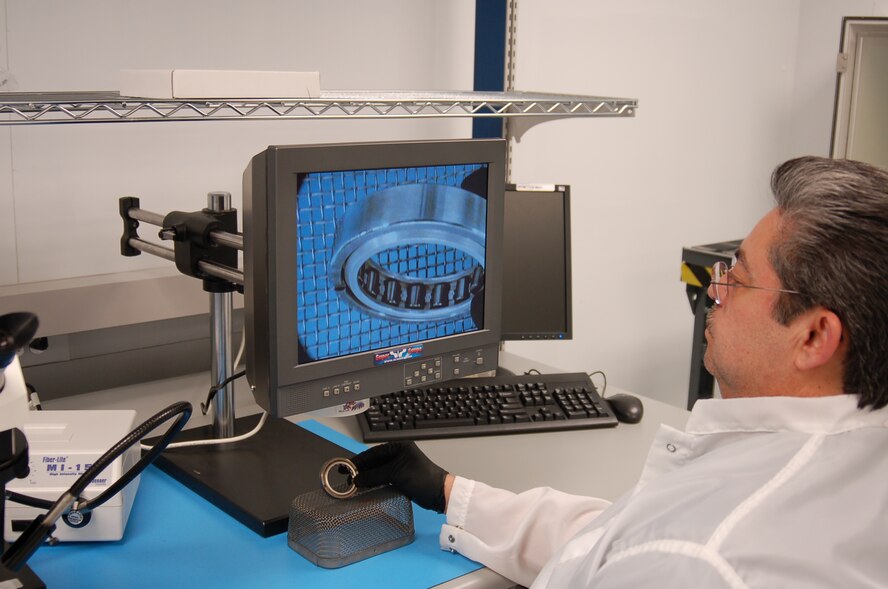 George Alviso views an enlarged image of a bearing set in the 530th Commodities Maintenance Squadron Bearing Shop. The visual inspection checks the bearing for flaws.

Photo by Bill Orndorff
