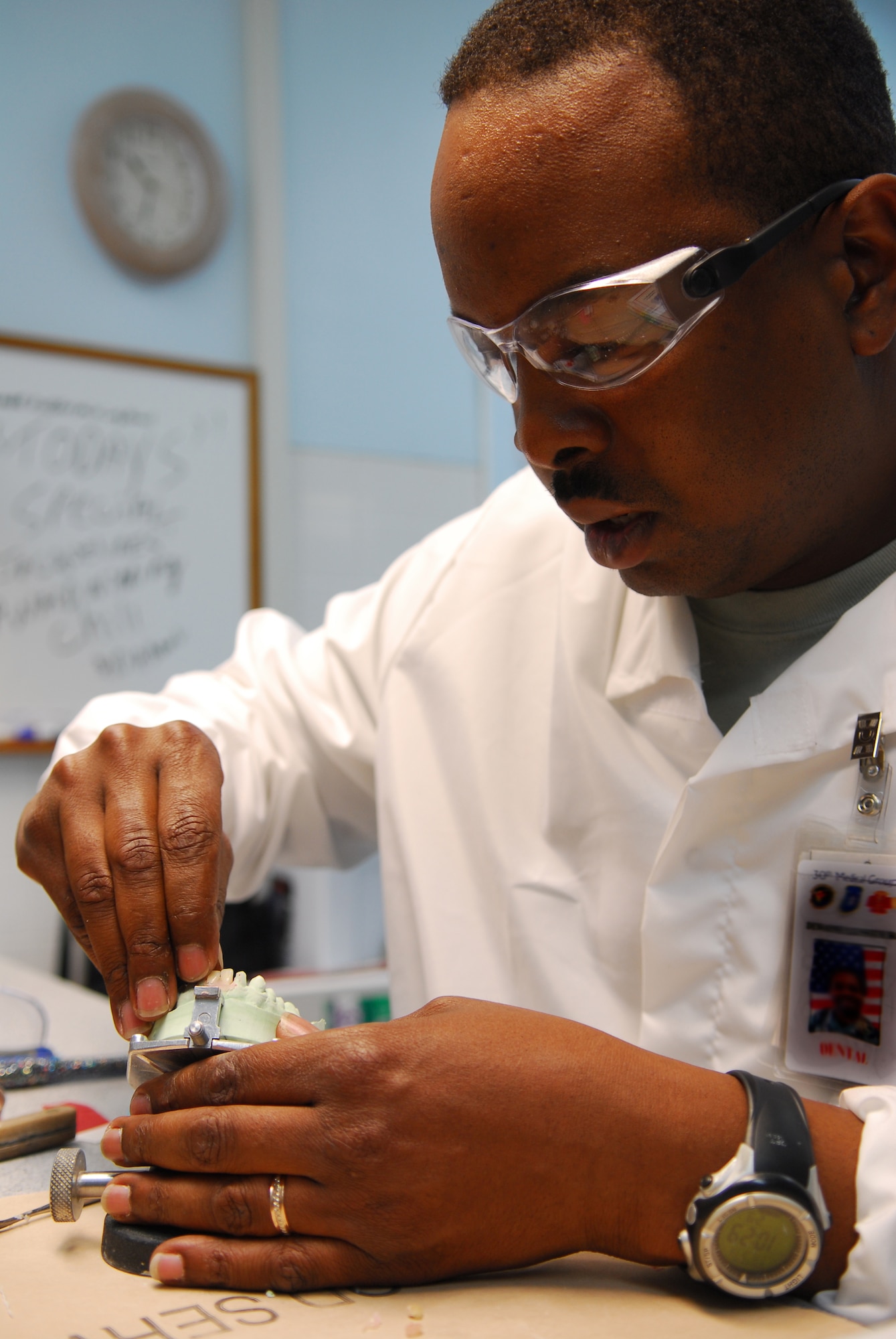 VANDENBERG AIR FORCE BASE, Calif. --  Tech. Sgt. Dewayne Luster, a dental lab technician with the 30th Medical Operations Squadron, inserts fake teeth into the model of a patient's mouth as part of the reconstruction process in the dental lab Mar 13. Dental technicians must use a combination of technical knowledge and artistic skill to create durable crowns and prosthesis. (U.S. Air Force photo/Senior Airman Ashley Hawkins)