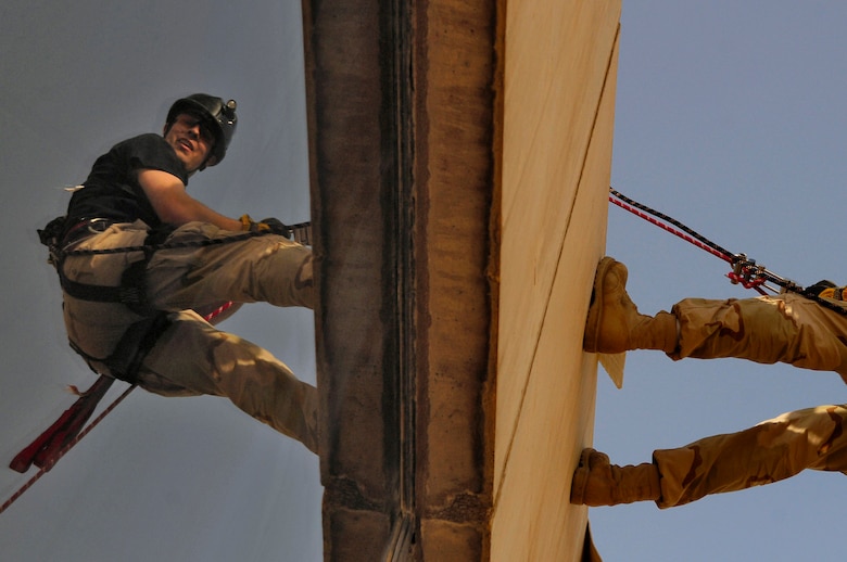 Staff Sgt. Grant Gimpel rappels from the roof of the Baghdad International Airport air traffic control tower during a training event March 3 at Sather Air Base, Iraq. The training is necessary in case controllers working in the 185-foot tower need to escape during an emergency. Sergeant Gimpel is a firefighter with the 447th Expeditionary Civil Engineer Squadron. (U.S. Air Force photo/Tech. Sgt. Jeffrey Allen) 