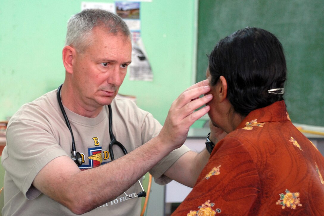 SOTO CANO AIR BASE, Honduras--Army Col. Mike Sigmon, JTF-Bravo MEDEL commander, examines a patient during the Medical Readiness Training Exercise March 10 in Morolica, Honduras. Managed by SOUTHCOM since 1989, the MEDRETE program is one of the premier engagement efforts in the region, giving U.S. military health care personnel the opportunity to have a positive impact on thousands of people who may not have had any medical care in years. (U.S. Air Force photo by Tech. Sgt. William Farrow)