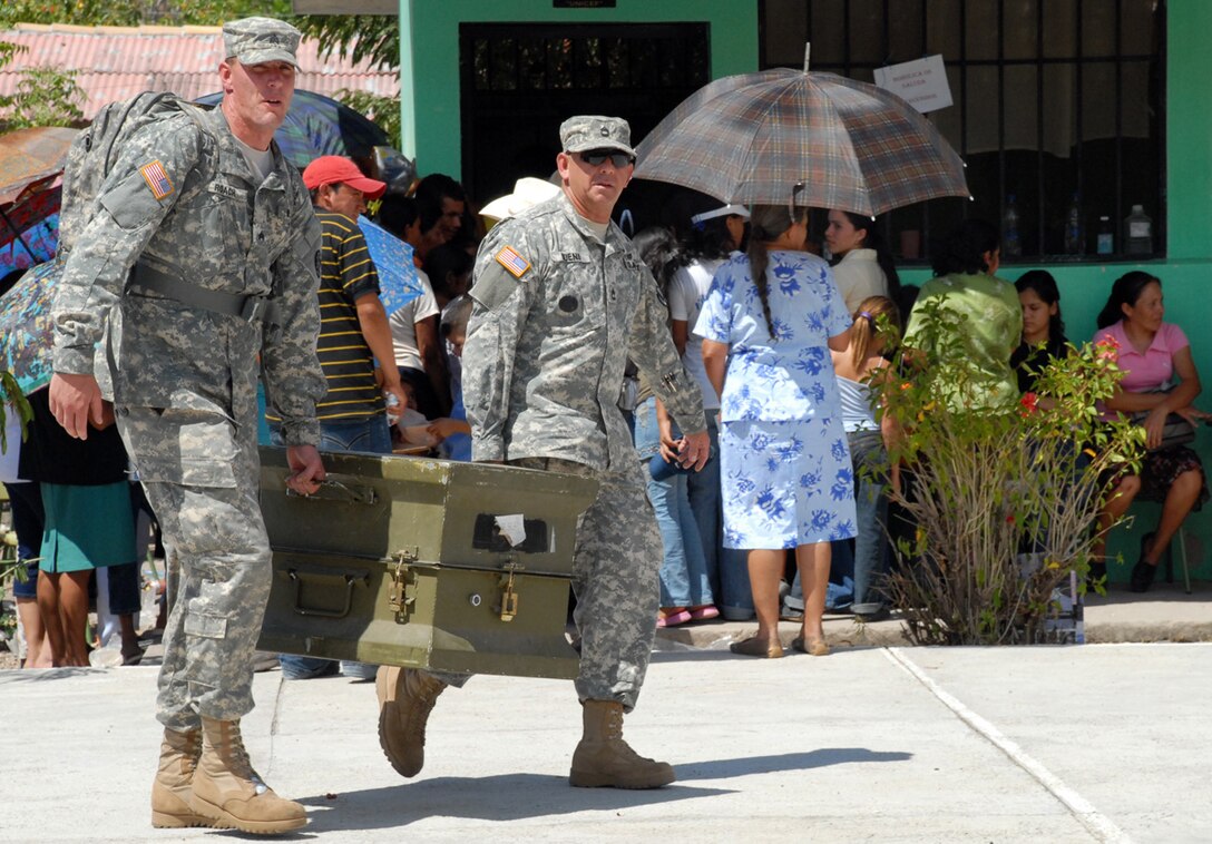 SOTO CANO AIR BASE, Honduras--As supplies are used up, Army Sgt. Christopher Roach and Army Sgt. 1st Class Galo Bueno, haul away a spent equipment bin during the March 10 MEDTRETE. More than $9000 of medical supplies were used during the medical exercise. (U.S. Air Force photo by Tech. Sgt. William Farrow) 