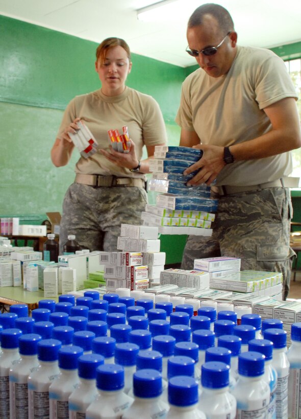 SOTO CANO AIR BASE, Honduras--Using a classroom as a makeshift pharmacy, Army Sgt. Rachel Mayhill and Air Force Capt. Manuel Silveira set up shop during the March 10 MEDRETE in Morolica, Honduras. MEDRETEs offer medical troops a one-of-a-kind opportunity to go through an entire deployment process and treat patients in the field training that is a departure from the typically simulated medical training exercises. (U.S. Air Force photo by Tech. Sgt. William Farrow) 