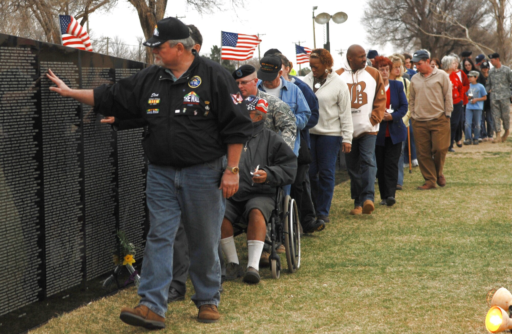 Veterans and town residents in Clovis, N.M., the home of Cannon Air Force Base, view the traveling Vietnam Wall March 15 to honor the memories of those who gave their lives during the Vietnam War.  The Wall is transported around the country to give people who otherwise may not be able to make the trip to Washington D.C. the opportunity see the Wall in their home town and pay their respects.  The Wall was on display in Clovis from March 14 to 18.  (U.S. Air Force photo/Airman 1st Class Liliana Moreno)