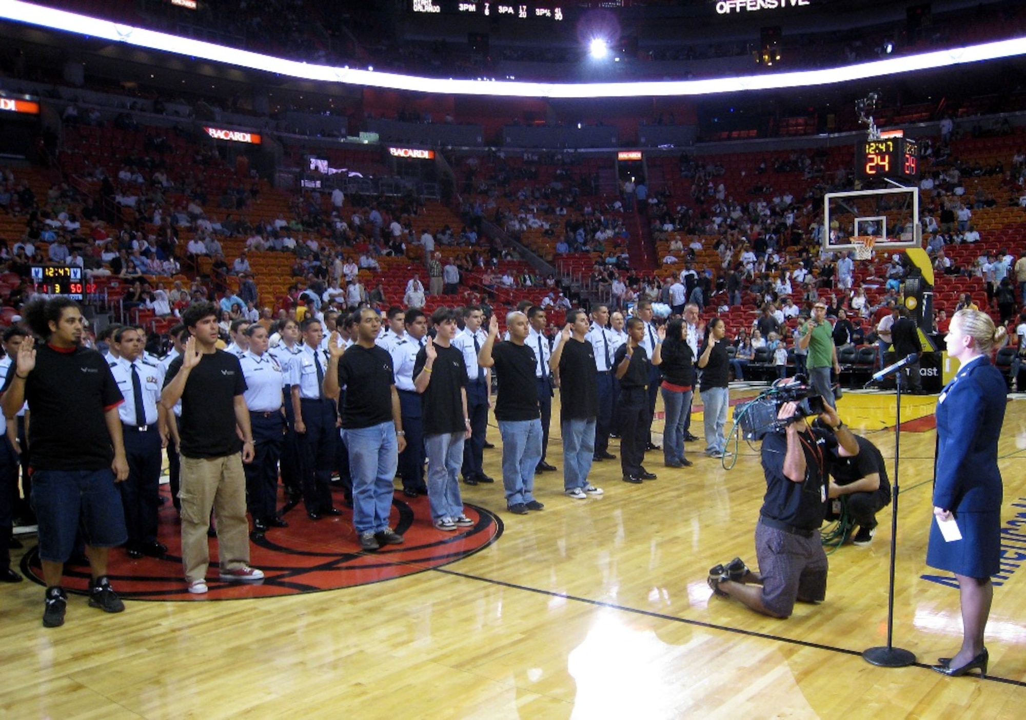 2nd Lt. Sabrina Ura, 482nd Mission Support Group executive officer, reads the oath of enlistment to 10 individuals joining the Air Force Reserve at “Air Force Reserve Night” during the Miami Heat game on March 14. The first-ever event, spearheaded by the 482nd Fighter Wing’s Recruiting Office, also featured the 482nd FW Honor Guard presenting the colors during the national anthem, and reservists volunteering at four informational kiosks scattered around the arena to help raise awareness about the Reserve. (U.S. Air Force photo/Staff Sgt. Leo Castellano)