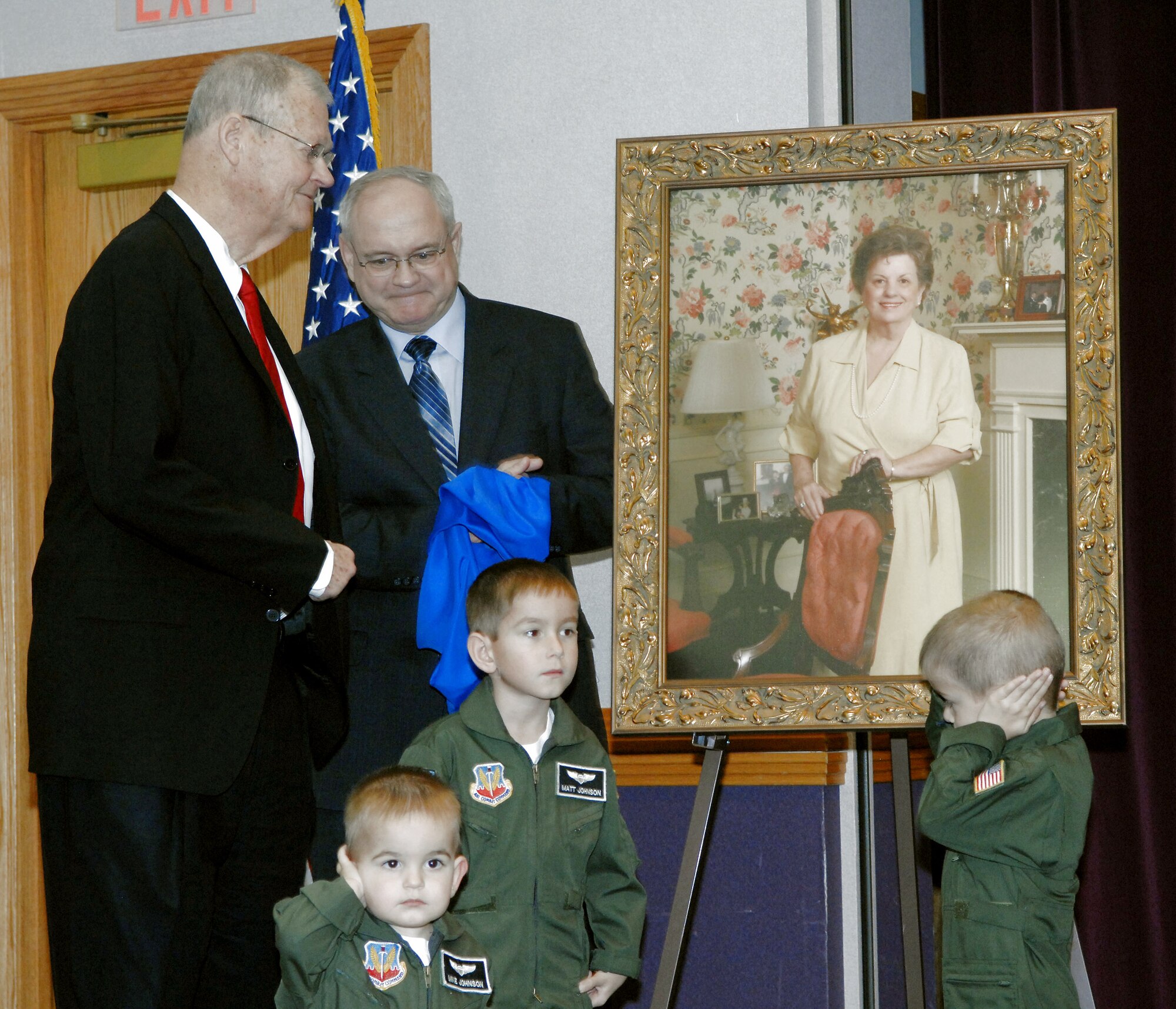 Rep. Ike Skelton (left), Dale Buckingham, Matthew Johnson, 5; Nathan Johnson, 4; and Michael Johnson, 1, unveil a painting of Susie Skelton during a Child Development Center dedication ceremony March 15 at Whiteman Air Force Base, Mo. Completed in 2007, the center was officially named the Susie Skelton Child Development Center in honor of her life, service and leadership to many civic and family organizations, for her dedication to the men and women in uniform, and in particular, for the advancement of children. The painting of Mrs. Skelton was commissioned by the Whiteman AFB Community Council and is now on display in the CDC foyer. Mr. Buckingham is the president of the Whiteman AFB Community Council. The children are sons of Lt. Col. Craig Johnson, the 509th Civil Engineer Squadron commander. (U.S. Air Force photo/Airman 1st Class Cory Todd) 
