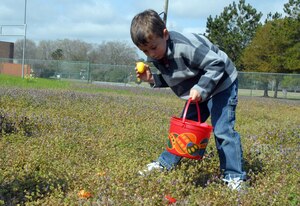 Brandon Feaster captures an egg during the Easter egg hunt at Youth Programs on base Saturday. Brandon is the 7-year-old son of Tech. Sgt. David Feaster. (U.S. Air Force photo/Airman 1st Class Melissa White)