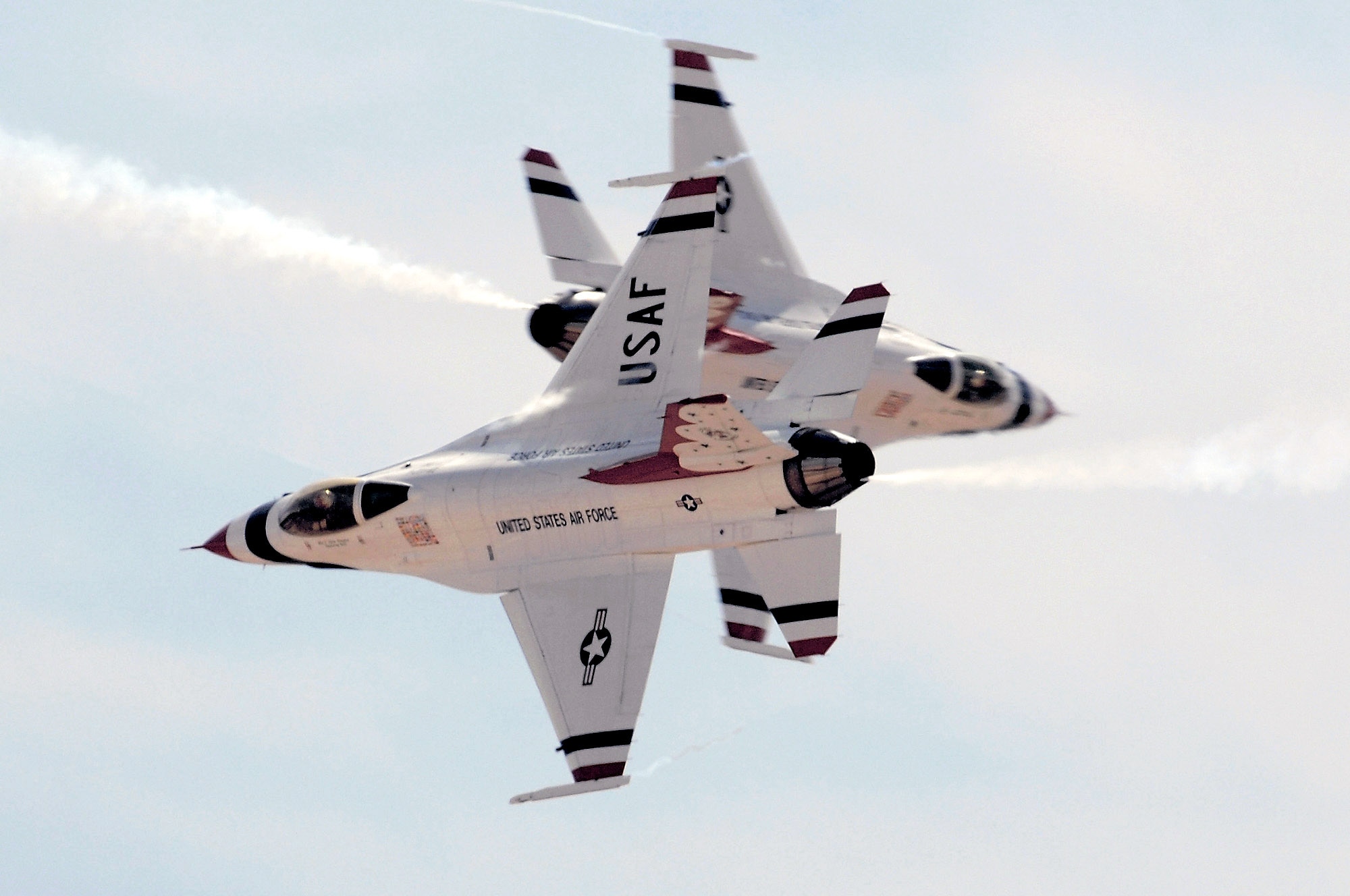The Air Force Thunderbirds solo pilots perform the crossover break maneuver during the March 11 acceptance show at Nellis Air Force Base, Nev. The acceptance show marks the beginning of the 2008 show season, which includes 37 showsites in the United States and Canada. (U.S. Air Force photo/Tech. Sgt. Justin D. Pyle) 
