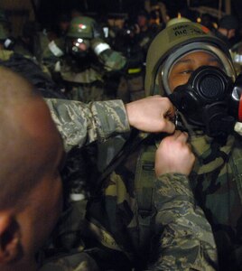LANGLEY AIR FORCE BASE, Va. -- Staff Sgt. Stephen Roby, 1st Maintenance Operations Squadron, performs a buddy check for Airman 1st Class Shaynea Green, 1st Operations Support Squadron, as she enters the training area of a Phase II Operational Readiness Exercise March 18. Airman Green was one of more than 1,000 Airmen who received the mandatory check before entering the play area. (U.S. Air Force photo/Senior Airman Vernon Young)