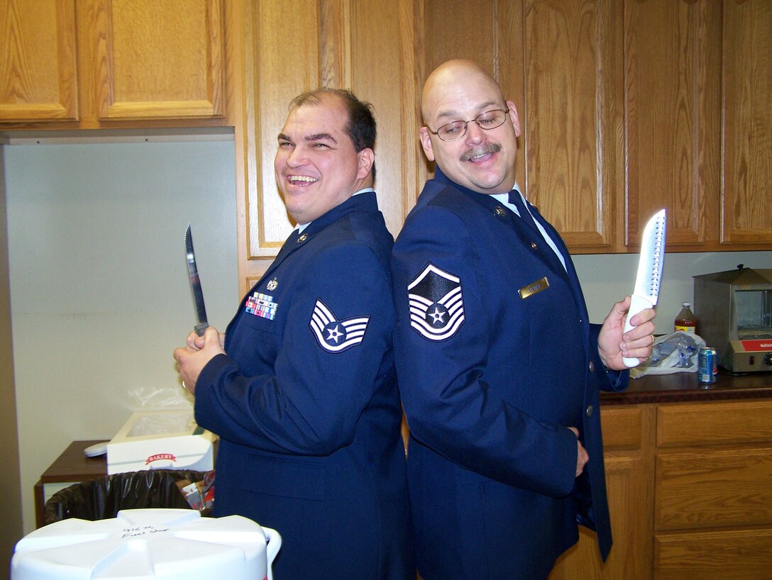 SEYMOUR JOHNSON AIR FORCE BASE, N.C. -- Tech. Sgt. Frank Premont (left) and Master Sgt. Karl Steiner, members of the 916th Maintenance Squadron, prepare to cut their retirement cake during the March unit training assembly. Both members have more than 40 years military service combined.