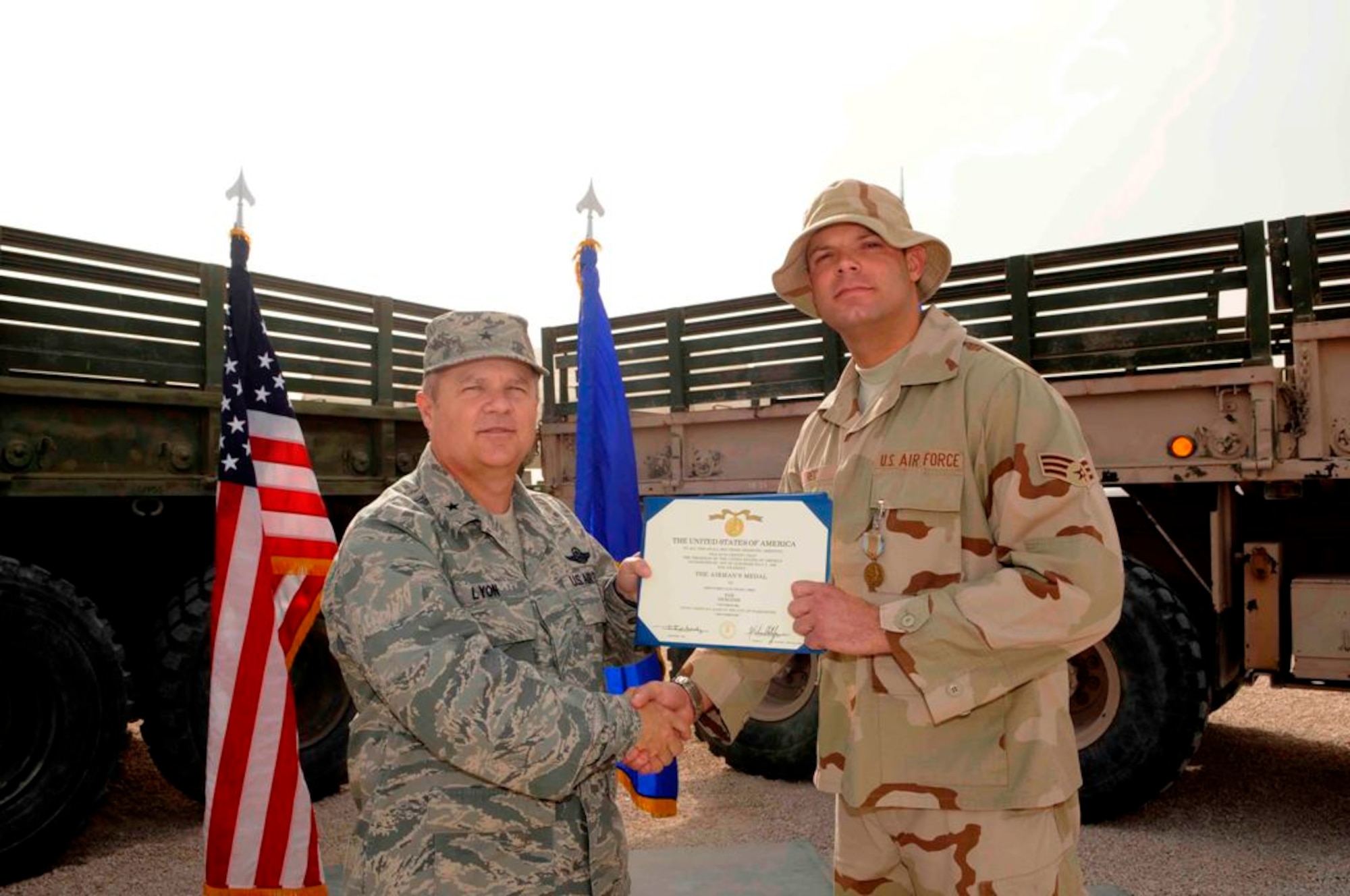 379th Air Expeditionary Wing commander Brig. Gen. Charlie Lyon presents Senior Airman Shane Reid an Airman’s Medal for heroism during a ceremony March 18 in Southwest Asia.  Airman Reid is deployed here from Spangdahlem Air Base, Germany.  (U.S. Air Force photo/Tech. Sgt. Johnny Saldivar)