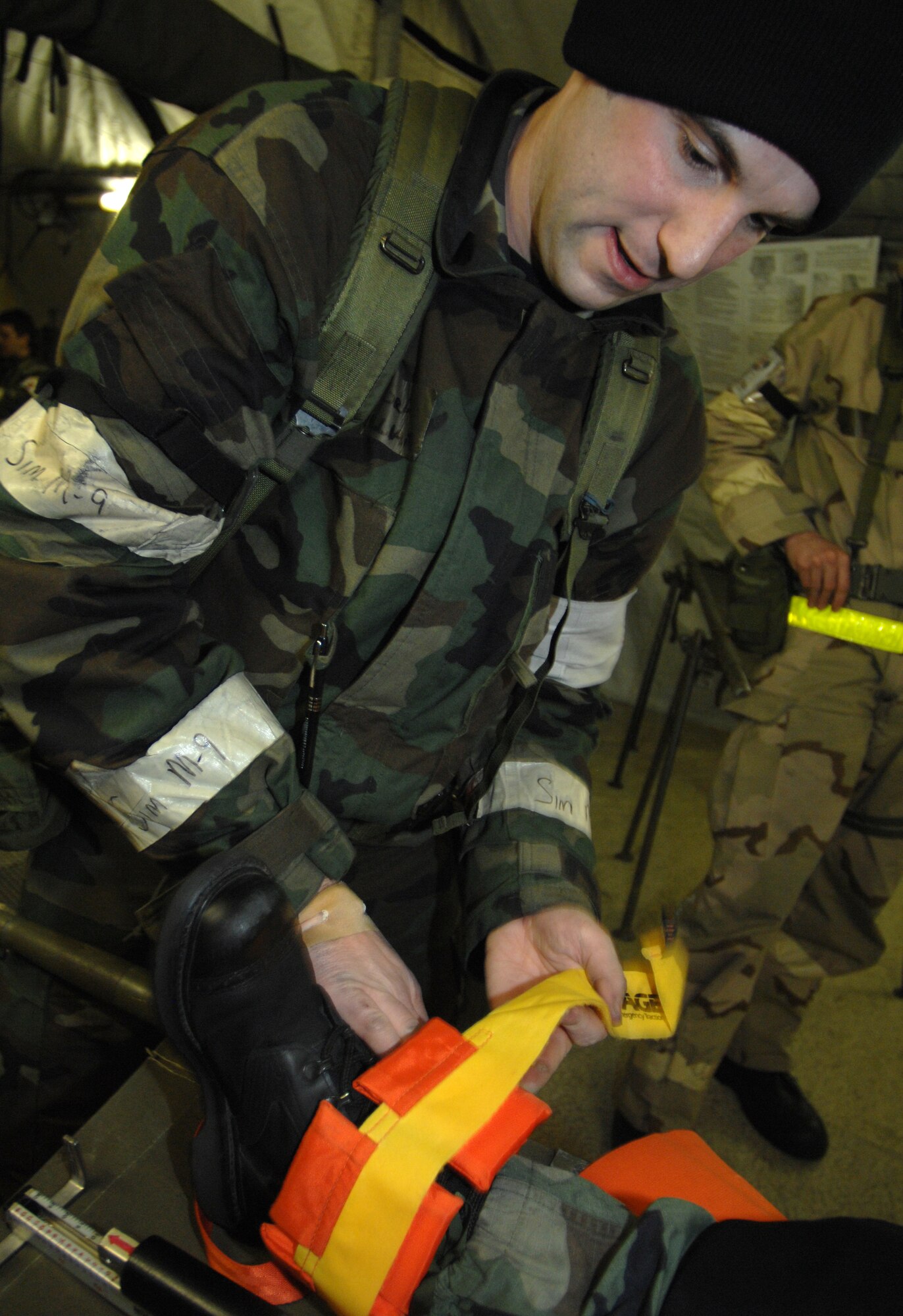 MOUNTAIN HOME AIR FORCE BASE, Idaho -- Airman Jack Williams, 366th Medical Operations Squadron medical technician, puts a splint on the leg of Airman 1st Class Rachel Burdridge, 366th Medical Operations Squadron medical technician, after she injured it during Exercise Coronet White 08-ACC-14 March 16. The 366th Fighter Wing is participating in an Operational Readiness Inspection March 13-21 to test the wing's ability to deploy and take its mission to war. (U.S. Air Force photo by Airman 1st Class Stephany Miller)