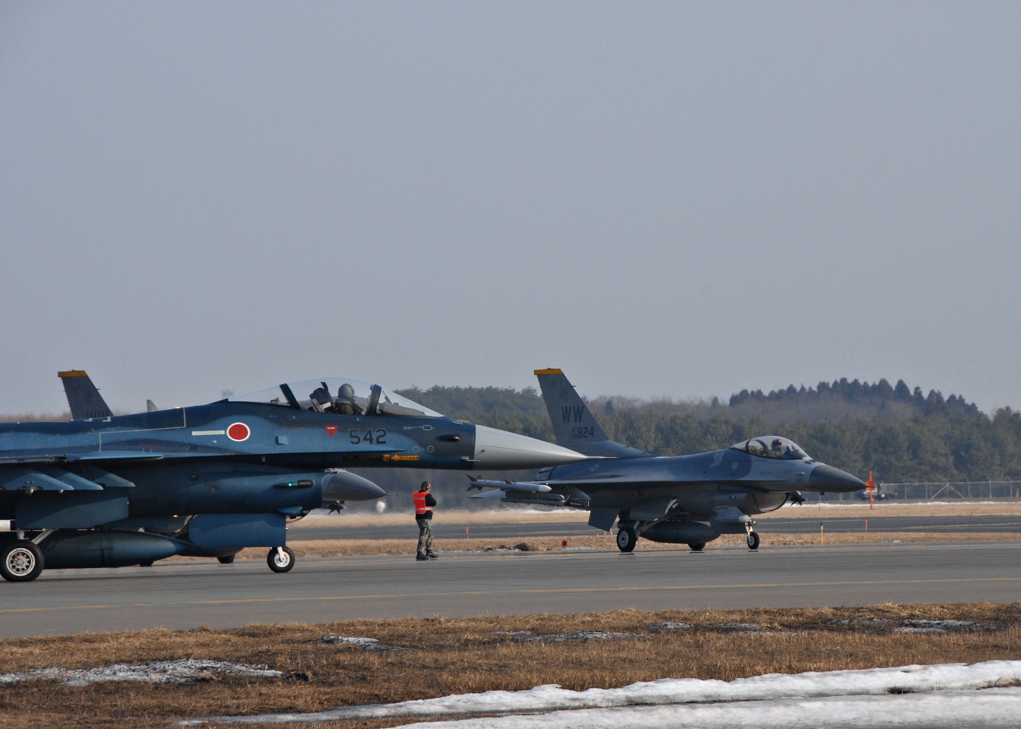 MISAWA AIR BASE, Japan -- A Japan Air Self Defense Force F-2 taxis in front of a U.S. Air Force F-16 on the flightline here March 11, 2008. JASDF and USAF units assigned to Misawa participated in Seikan War, a bilateral air exercise, from March 10-13, 2008. (U.S. Air Force photo by Staff Sgt. Rachel Martinez)