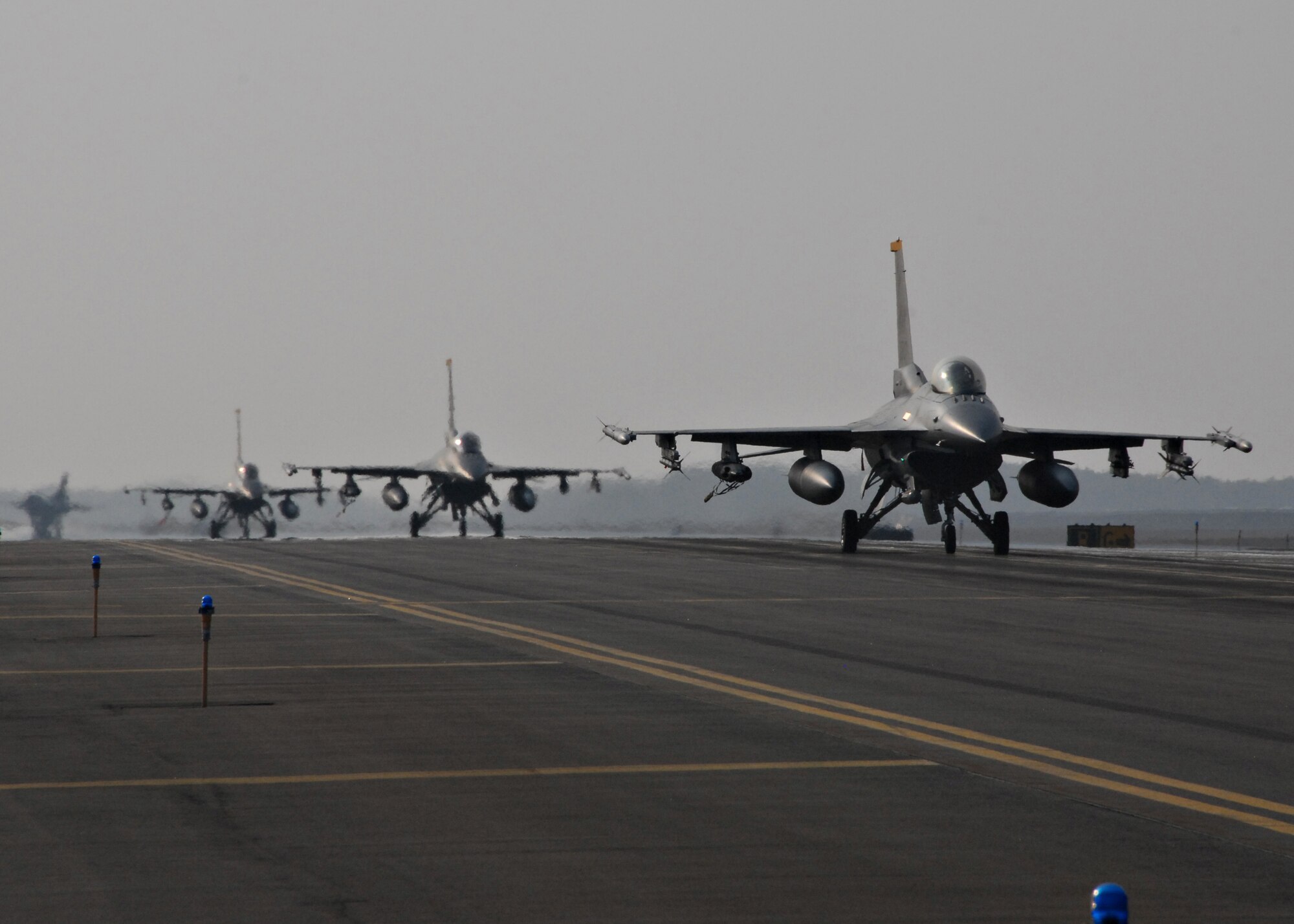 MISAWA AIR BASE, Japan -- Several F-16 Fighting Falcons taxi down the Misawa runway during Seikan War March 11, 2008. Seikan War is a bilateral exercise with the Japan Air Self Defense Force and features F-16s, F-15s, F-4s and F-2s.  (U.S. Air Force photo by Staff Sgt. Rachel Martinez)