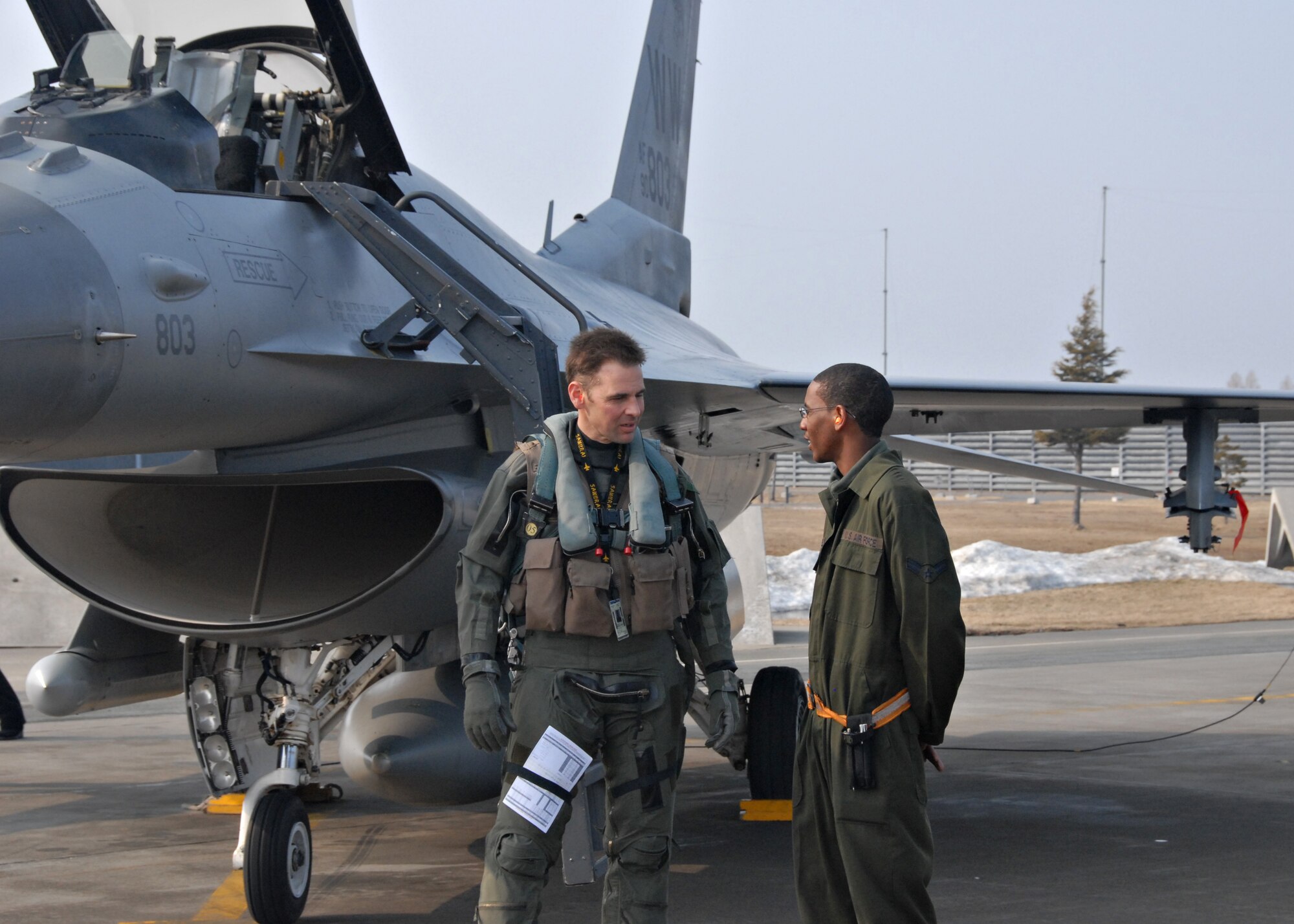 MISAWA AIR BASE, Japan -- Lt. Col. Charles Toplikar, 14th Fighter Squadron commander, talks with Airman 1st Class Alvin Felder, 35th Aircraft Maintenance Squadron crew chief, during a pre-flight inspection March 11, 2008. Colonel Toplikar and other 14th Fighter Squadron members participated in Seikan War, a joint bilateral air exercise, with the Japan Air Self Defense Force from March 10-13, 2008. (U.S. Air Force photo by Staff Sgt. Rachel Martinez)