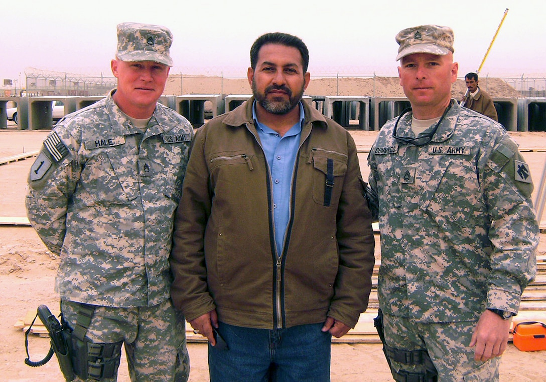 Army Staff Sgt. Russell Hale, left, Ali Jihad, an Iraqi construction supervisor, and Army Sgt. 1st Class Rafe Cummings stand in front of a construction site at Camp Bucca, Iraq. U.S. Army photo by Lt. Col. Rhonda McGuire