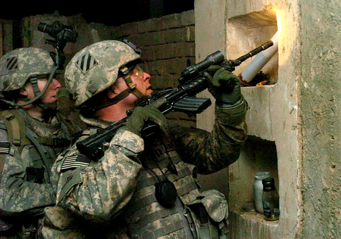 Capt. Jared Albright, commander of Troop B, 3rd Squadron, 1st Cavalry Regiment, searches a building during a night raid in Narhwan, Iraq, March 16. During the raid, Troop B cleared three houses and detained four individuals, including a man designated as a "high-value target." U.S. Army photo by Spc. Ben Hutto