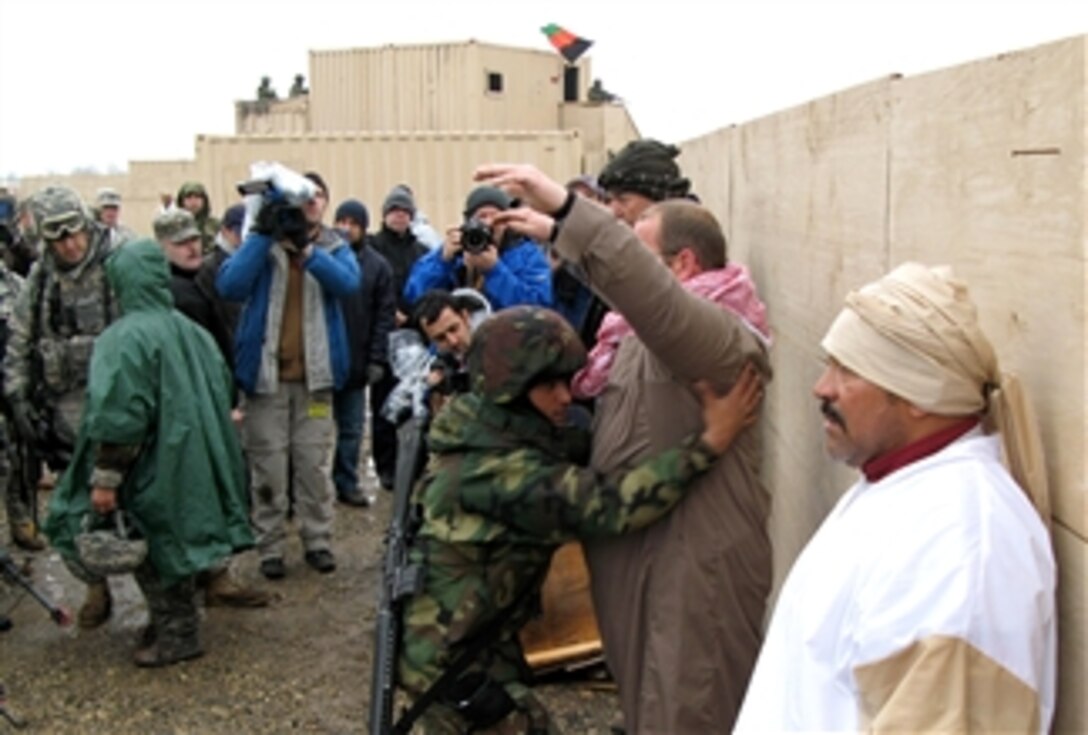 An Afghan National Army soldier searches a “suspect” during U.S. advisor team training on Fort Riley, Kan., March 17. U.S. soldiers of the 1st Infantry Division's 1st Brigade Combat Team, with help from Afghan soldiers and contract employees, have trained thousands of deploying troops. 