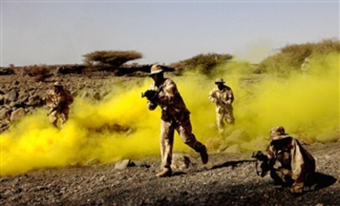 Djiboutian army soldiers funnel two vehicles into an ambush during Operation Able Dart 08-01, part of a counterterrorism tactic course taught by U.S. Army soldiers on Forward Operating Location Dikhil, Djibouti, March 6, 2008. 