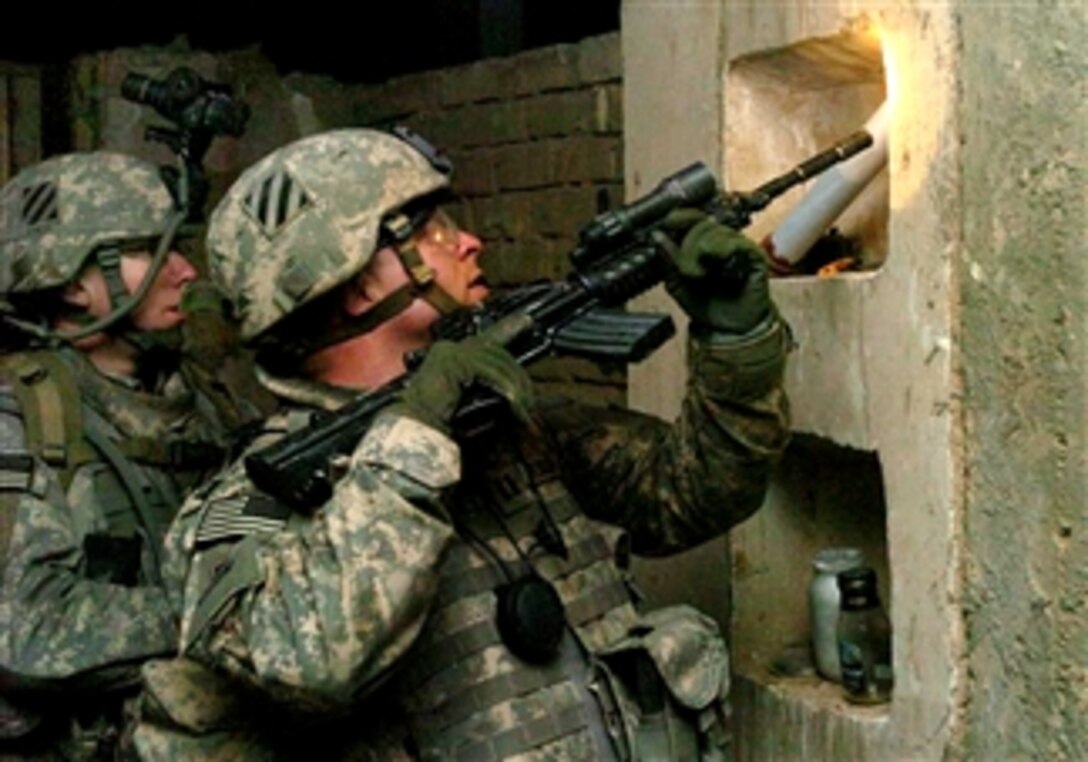 U.S. Army Capt. Jared Albright searches a building during a night raid in Narhwan, Iraq, March 16, 2008. During the raid, Troop B cleared three houses and detained four individuals, including a man designated as a "high-value target." 