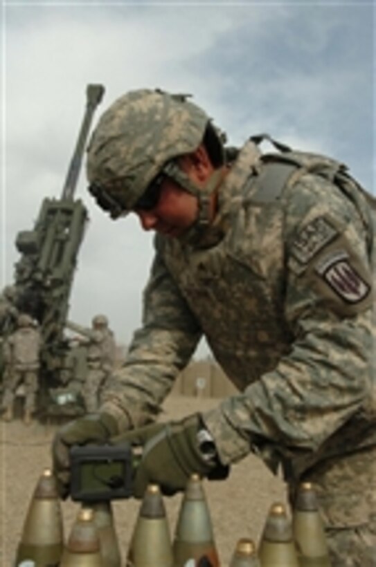 Sgt. Joseph Sullivan uses a portable inductive fuse setter to set and activate rounds to be fired from an M-777 howitzer during a training exercise on Forward Operating Base Salerno, Afghanistan, on Feb. 28, 2008.  Sullivan is an ammo team chief with the U.S. Armyís 3rd Battalion, 321st Field Artillery Regiment, 18th Field Artillery Brigade.  