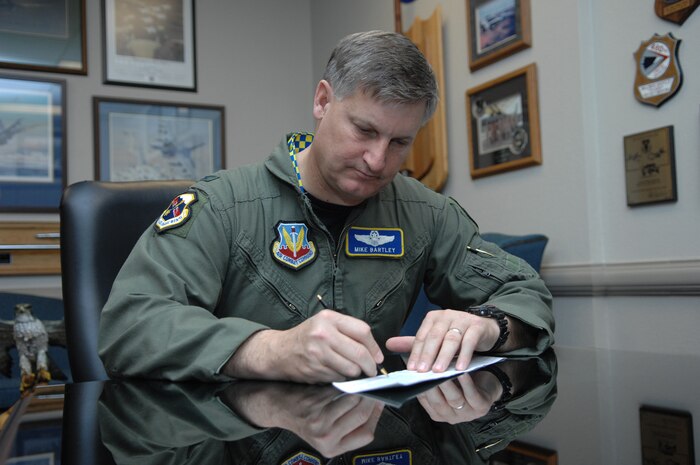 NELLIS AIR FORCE BASE, Nev. -- Col. Michael Bartley, 99th Air Base Wing commander, makes a donation to the Air Force Assistance Fund on Nellis, March 18. The AFAF will officially kick off at Nellis March 31 and end May 9. The AFAF is an annual effort to raise funds for charitable affiliates who provide support to the Air Force family; the goal is for 100 percent contact of Air Force personnel for contributions. (U.S. Air Force photo/Senior Airman Larry Reid)