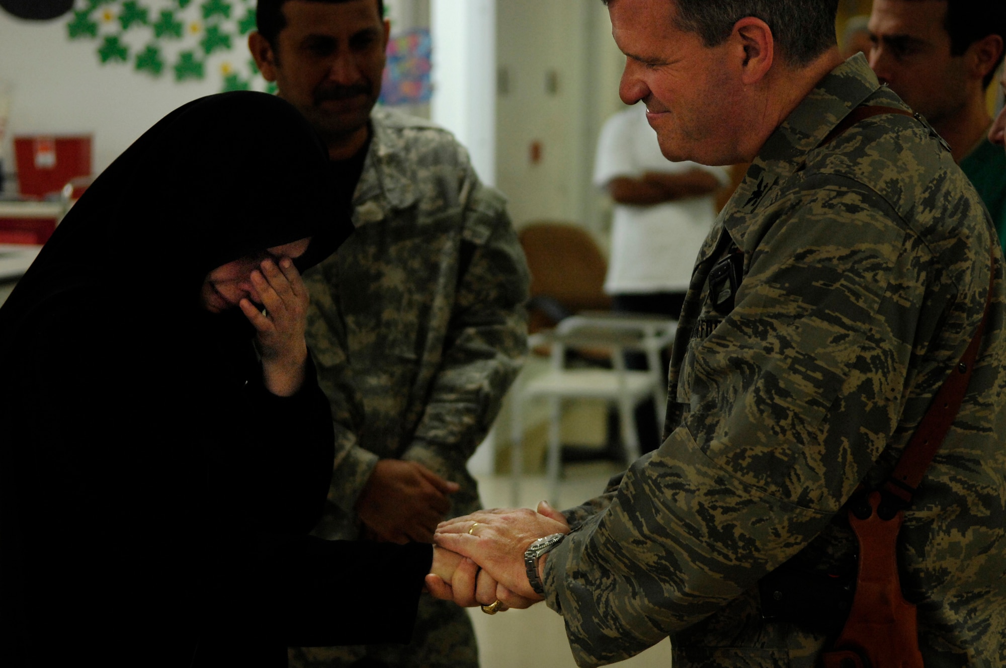 BALAD AIR BASE, Iraq -- Col. Timothy Halligan, 332nd Expeditionary Medical Group deputy commander, consoles Amil,  the mother of Al Amreeki, a 3-year-old burn victim, as she formally thanks the staff at the Air Force Theater Hospital for saving her son's life, March 19. (U.S. Air Force Photo/Tech. Sgt. Jeffrey Allen) 