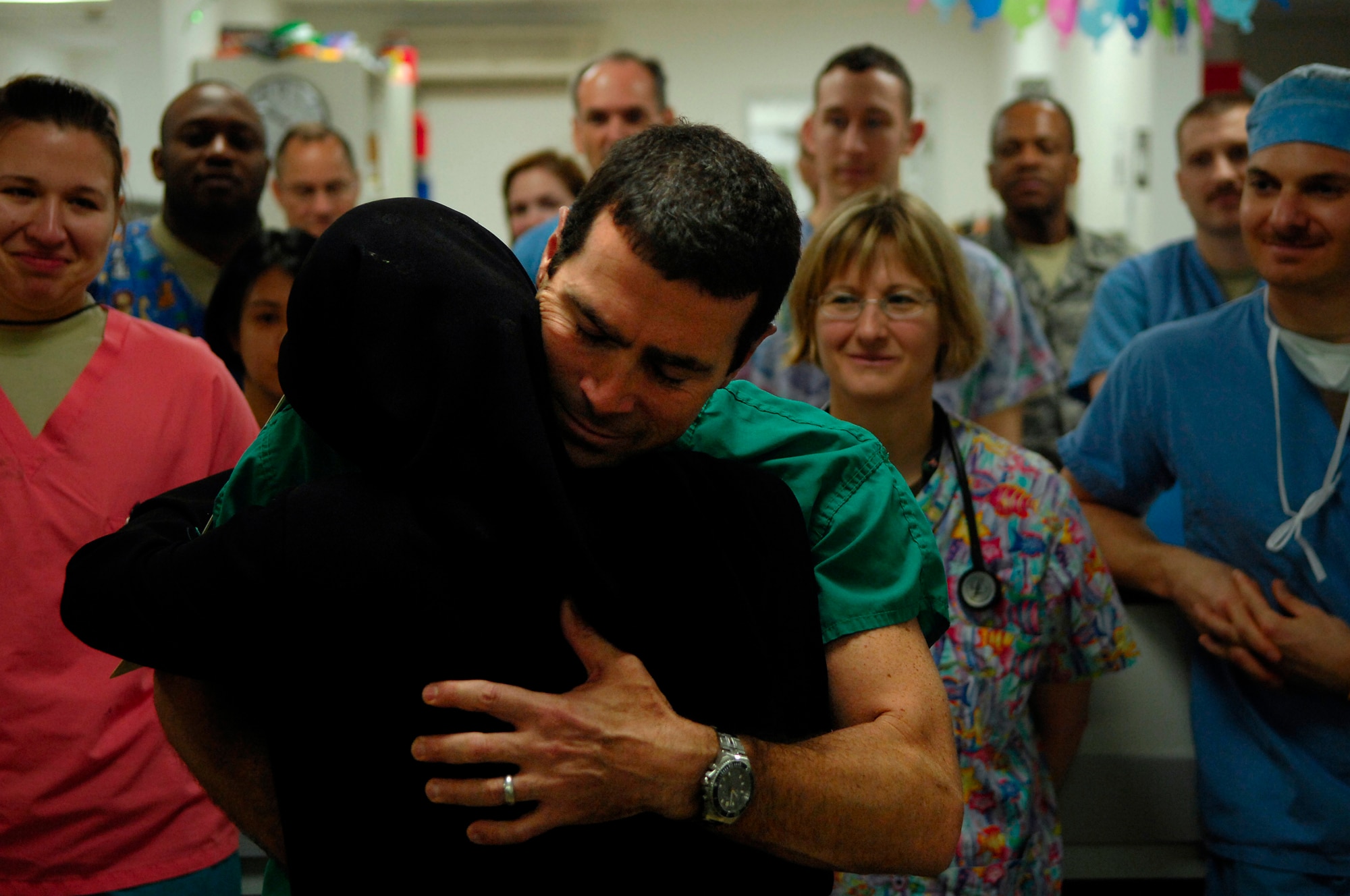 BALAD AIR BASE, Iraq -- Capt. Michael Riegler, 332nd Expeditionary Medical Operations Squadron nurse, hugs Amil, the mother of Al Amreeki, a 3-year-old burn victim, after she formally thanked the staff at the Air Force Theater Hospital here for saving her son's life March 19. (U.S. Air Force Photo/Tech. Sgt. Jeffrey Allen) 