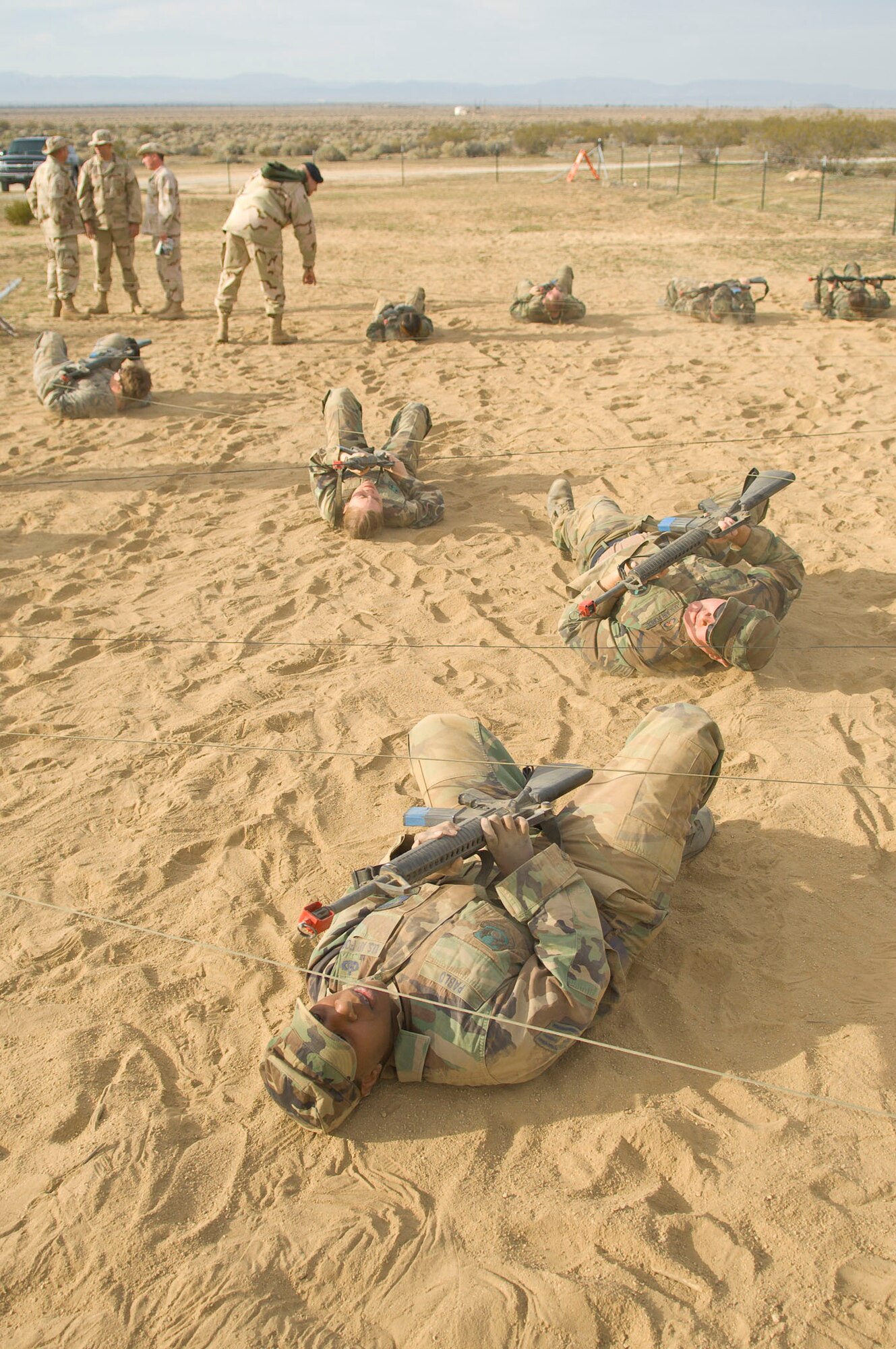 Edwards Airmen go through an obstacle course during the base's Phase II portion of the Operational Readiness Exercise at Camp Corum here March 12. Edwards held the ORE March 10 to 14 to test the base's ability to deploy Airmen downrange and then the Airmen's ability to survive and operate in a deployed location.(Air Force photo by Mike Cassidy)