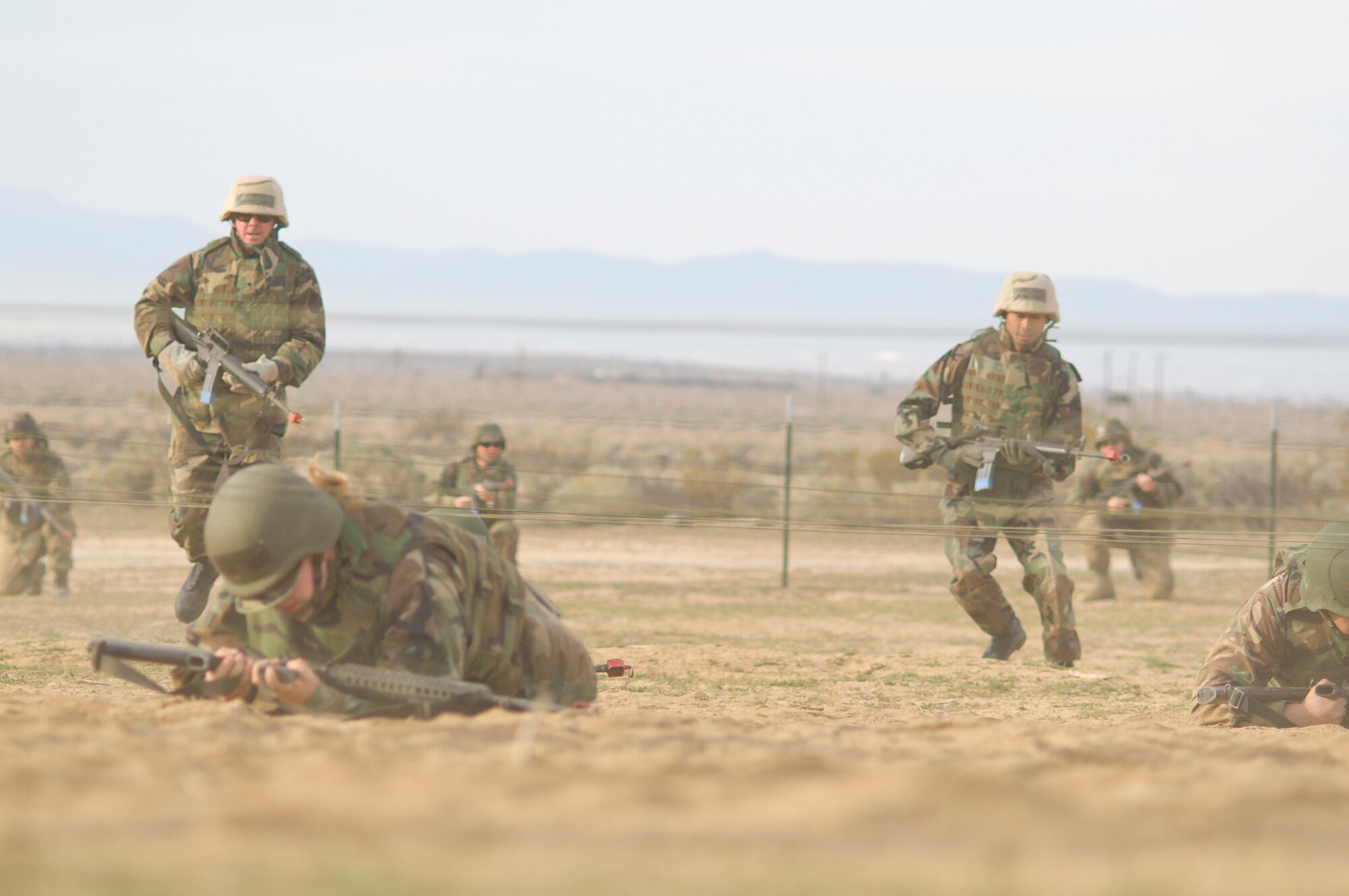 Edwards Airmen go through an obstacle course during the base's Phase II portion of the Operational Readiness Exercise at Camp Corum here March 12. Edwards held the ORE March 10 to 14 to test the base's ability to deploy Airmen downrange and then the Airmen's ability to survive and operate in a deployed location.(Air Force photo by Mike Cassidy)