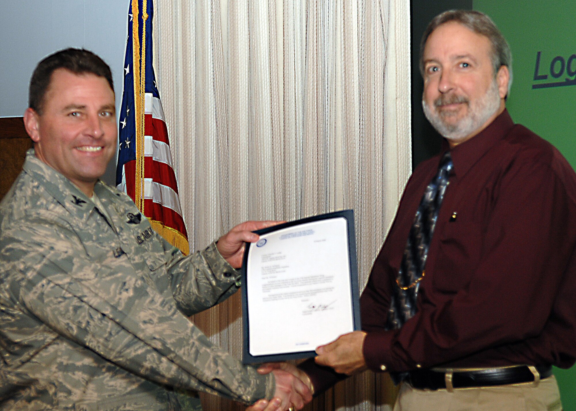 CANNON AIR FORCE BASE, N.M. - Mr. James Williams, 27th Special Operations Logistics Readiness Squadron Logistics Manager, receives the Logistics Readiness Senior Civilian Manager of the Year award presented by Col. Timothy Leahy on March 19. (U.S. Air Force photo by Airman Basic Danielle Martin)