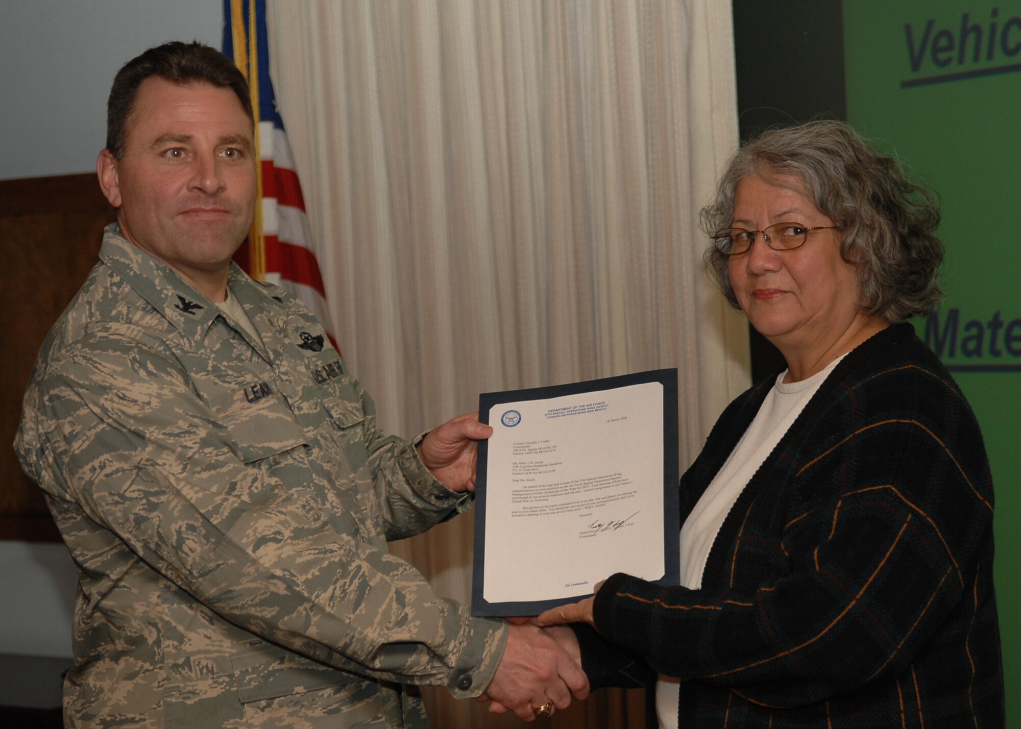 CANNON AIR FORCE BASE, N.M. - Ms. Mary Smith, 27th Special Operations Logistics Readiness Squadron Stock Control Technician, receives the Material Management Civilian Technician of the Year award presented by Col. Timothy Leahy, 27th Special Operations Wing commander on March 18. (U.S. Air Force photo by Airman Basic Danielle Martin)