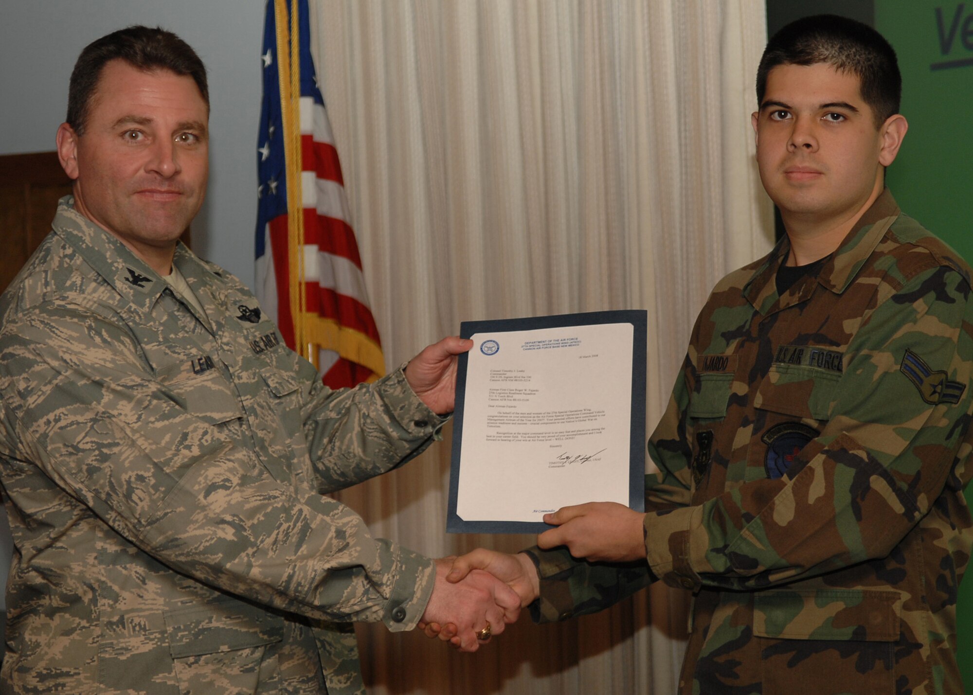 CANNON AIR FORCE BASE, N.M. - Airman 1st Class Roger Fajardo, 27th Special Operations Logistic Readiness Squadron, receives the Vehicle Management Airman of the Year award presented by Col. Timothy Leahy, 27th Special Operations Wing commander on March 18. (U.S. Air Force photo by Airman Basic Danielle Martin)