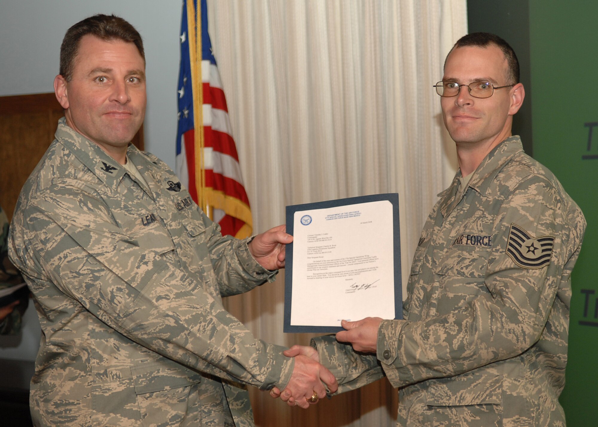 CANNON AIR FORCE BASE, N.M. - Tech Sgt. Charles Roop, 27th Special Operations Logistic Readiness Squadron, receives the Traffic Management Non Commissioned Officer of the Year award presented by Col. Timothy Leahy, 27th Special Operations Wing commander on March 18. (U.S. Air Force photo by Airman Basic Danielle Martin)