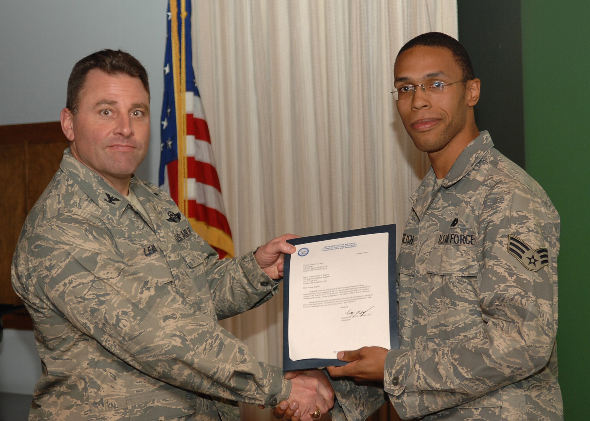 CANNON AIR FORCE BASE, N.M. - Senior Airman Nelson English, 27th Special Operations Logistics Readiness Squadron, receives the Fuels Airman of the Year award presented by Col. Timothy Leahy, 27th Special Operations Wing commander on March 18. (U.S. Air Force photo by Airman Basic Danielle Martin)
