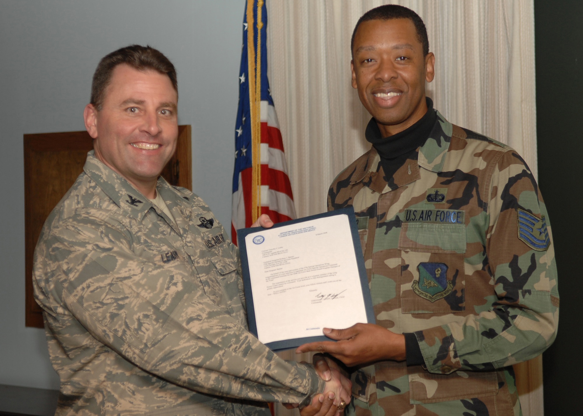 CANNON AIR FORCE BASE, N.M. - Tech Sgt Rodney Barner, 27th Special Operations Services Squadron, receives the Base Honor Guard Program Manager of the Year award presented by Col. Timothy Leahy, 27th Special Operations Wing commander March 18. (U.S. Air Force photo by Airman Basic Danielle Martin)

