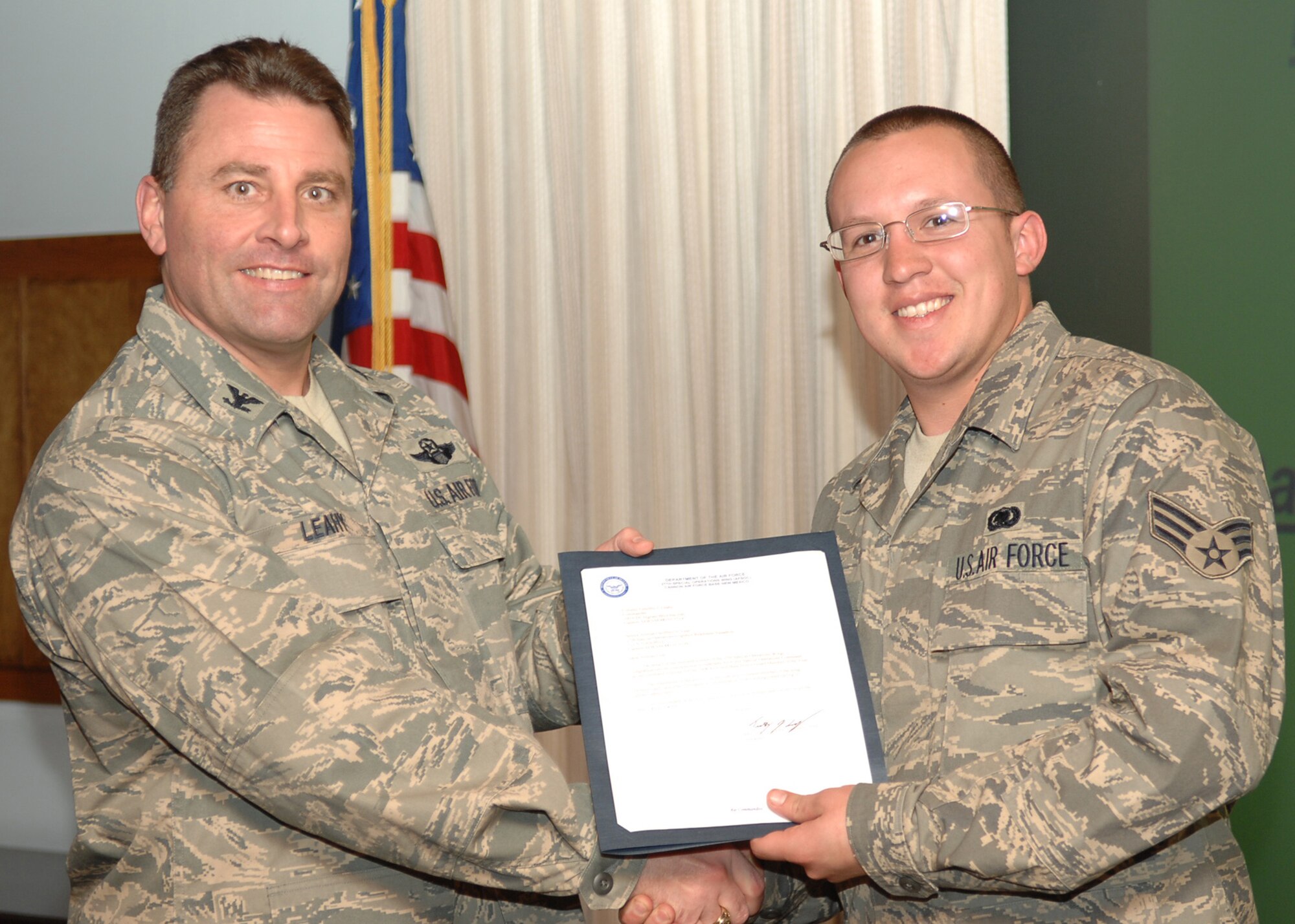CANNON AIR FORCE BASE, N.M. - Senior Airman Geoffrey Leal, 27th Special Operations Logistics Readiness Squadron, receives the Base Honor Guard Member of the Year award presented by Col. Timothy Leahy, 27th Special Operations Wing commander. (U.S. Air Force photo by Airman Basic Danielle Martin)

