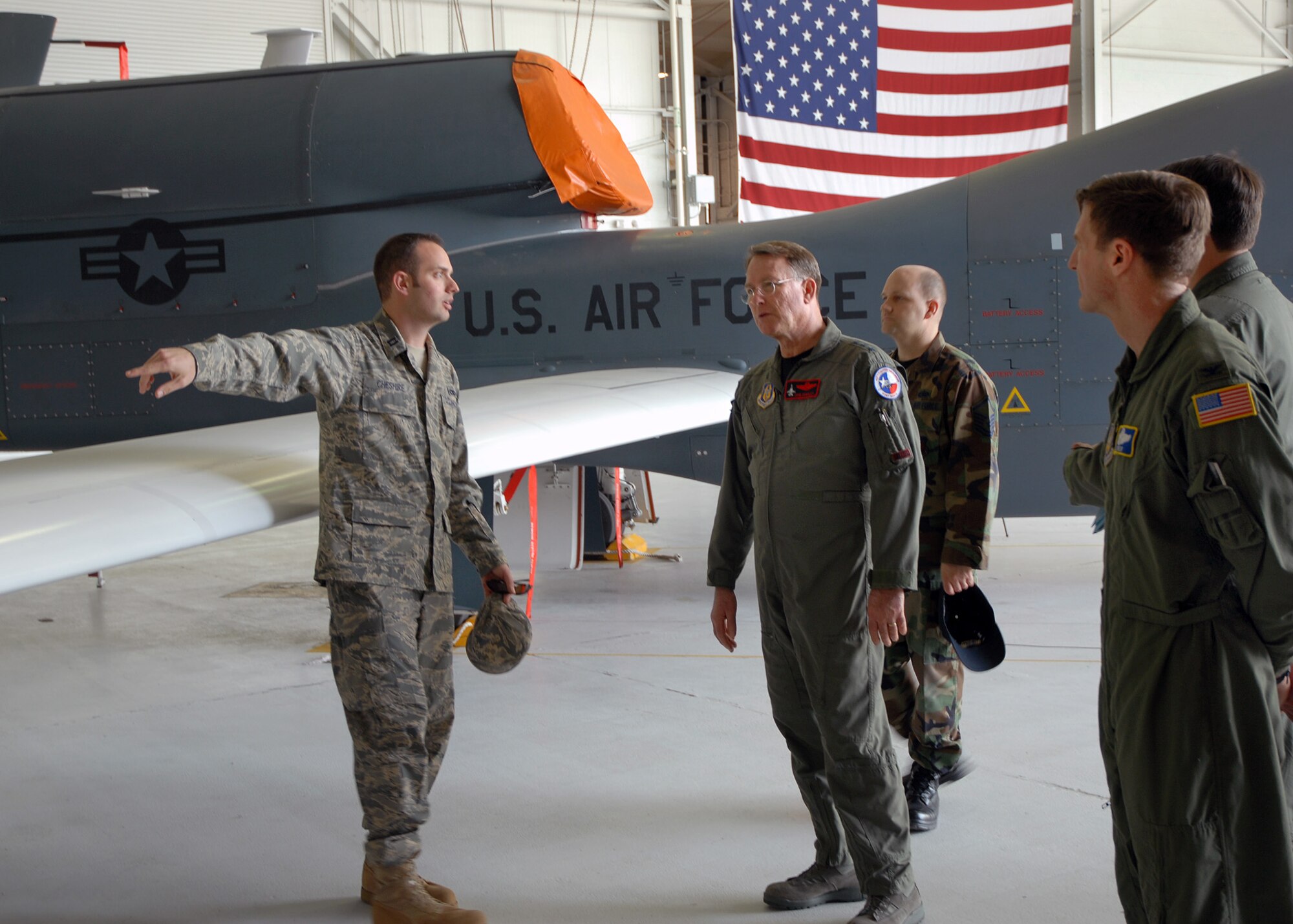 BEALE AIR FORCE BASE, Calif. -- Capt. Christopher Cheshire, a maintenance officer with the Air Force Reserve's 13th Reconnaissance Squadron, briefs features of the RQ-4 Global Hawk to Lt. Gen. John A. Bradley, chief of Air Force Reserve and commander, Air Force Reserve Command, during the general's visit here March 12, 2008.  Reserve Airmen at Beale are building a classic-associate relationship with the 9th Reconnaissance Wing to help maintain and operate the high-altitude unmanned aerial vehicle. While the 940th Air Refueling Wing is drawing down its legacy KC-135R mission, as directed by the Base Closure and Realignment Commission, Beale Reservists are partnering with active duty Airmen to support emerging command and control, and intelligence, surveillance and reconnaissance missions.  In accordance with the 2005 BRAC, Beale's Reserve expeditionary combat support elements continue unchanged through the transition.  (U.S. Air Force photo/ Maj. Robert Couse-Baker)
