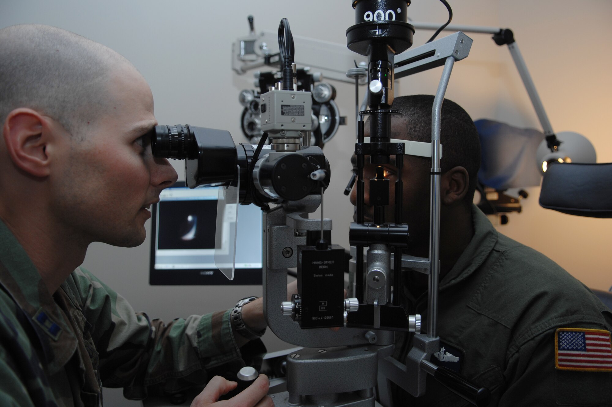 MOODY AIR FORCE BASE, Ga. – Capt. Nathan Anderson, 23rd Aerospace Dental Squadron optometrist, uses a biomicroscope during an eye exam on Staff Sgt. Mario McBride, 71st Rescue Squadron loadmaster, here March 4.  The biomicroscope was used to evaluate the health of the ocular.  (U.S. Air Force photo by Senior Airman Angelita Lawrence) 