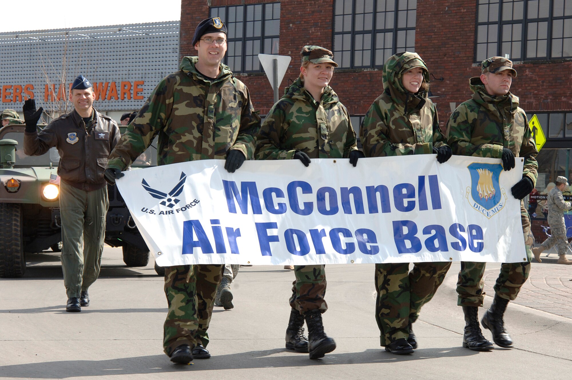MCCONNELL AIR FORCE BASE, Kan. – Senior Airmen from the McConnell Airman Leadership School: Thomas Murray, Janet Alworth, Jamie Train and Zac Laird represent McConnell in a St. Patrick’s Day Parade down town Wichita, March 15. Col. James Vechery, 22nd Air Refueling Wing commander and a float of family members of deployed Airmen precede them, waving to the crowd. (Photo by Staff Sgt. Ronald Lafosse)