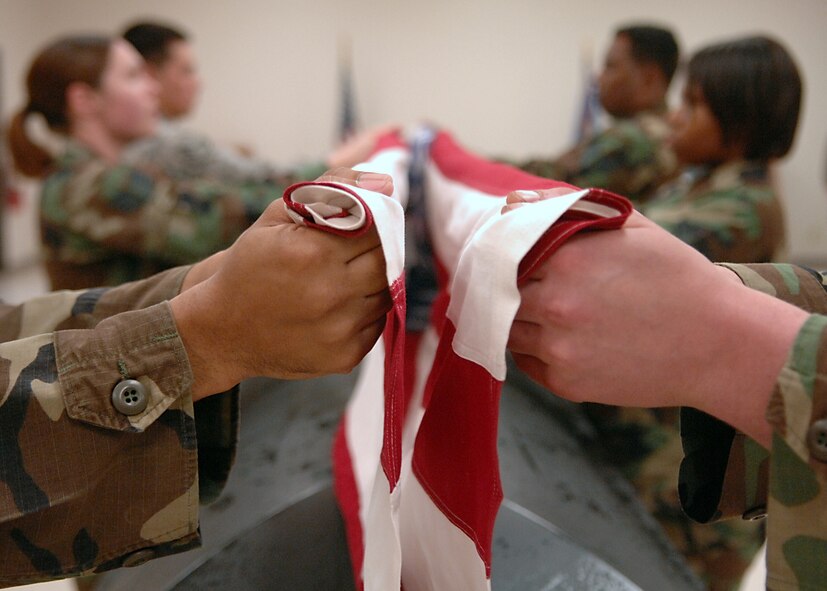 MOODY AIR FORCE BASE, Ga. -- Members of the 23rd Wing Honor Guard red flight, practice folding a flag for an upcoming retired service member's funeral. The seven-man team folds the flag exactly 13 times before it is presented to the family of the deceased. (U.S. Air Force photo by Airman 1st Class Brittany Barker)